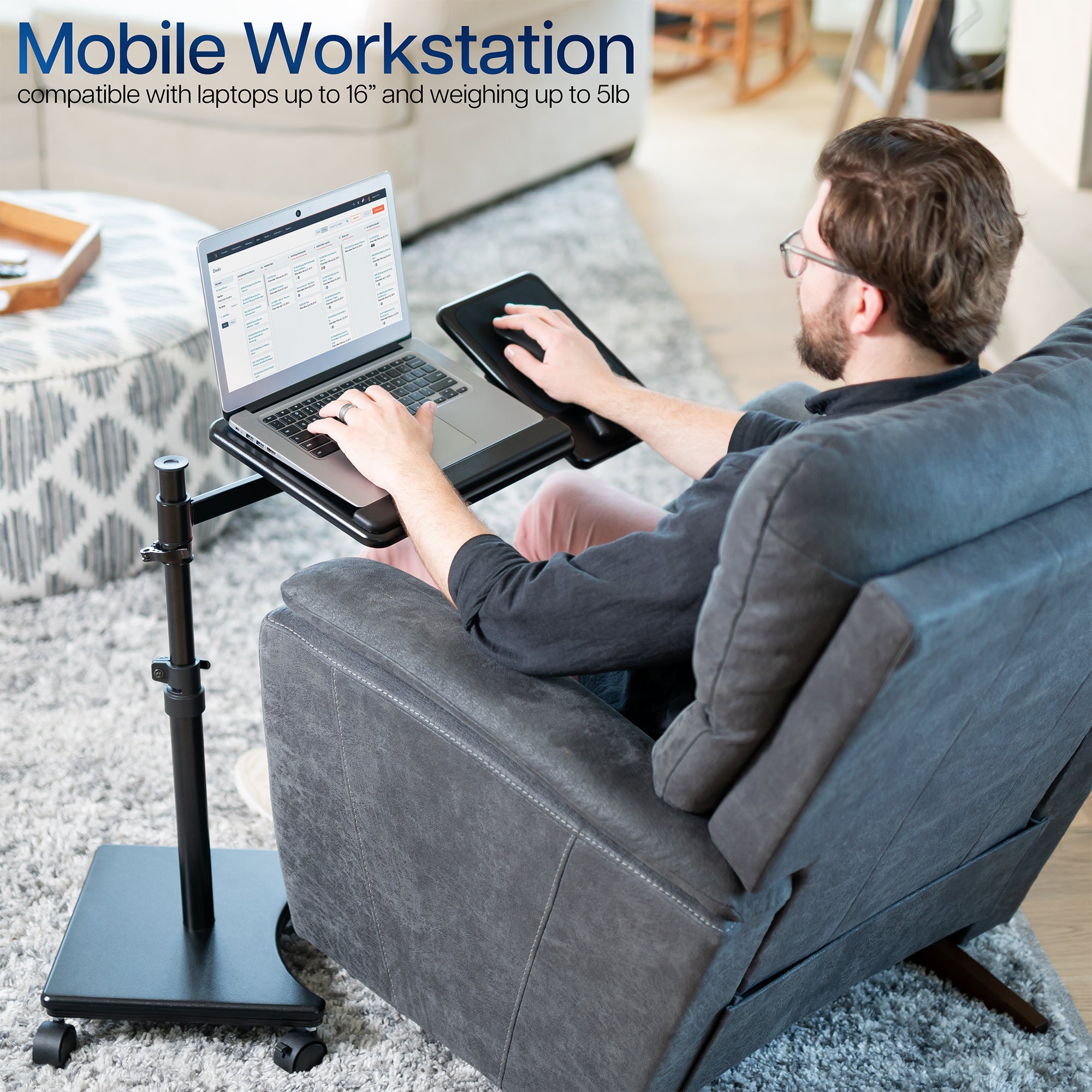 Person using a laptop on a portable desk in a living room setting