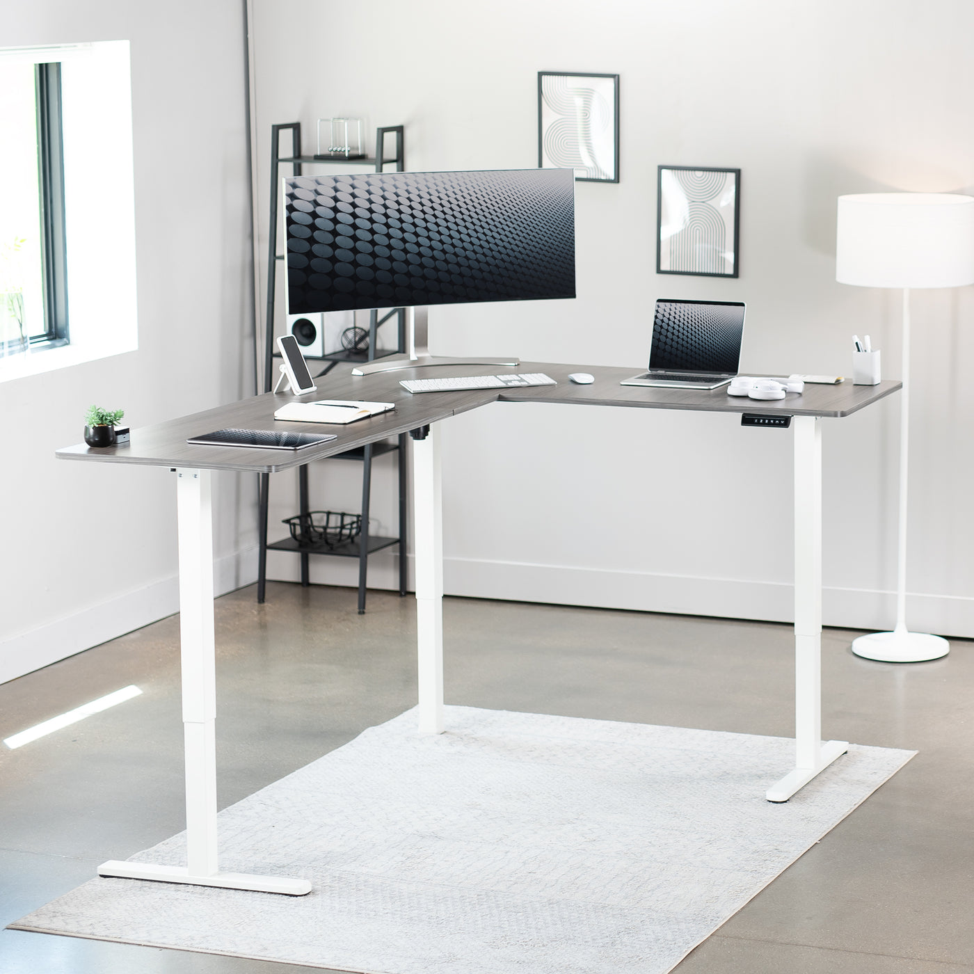 Electric heavy-duty corner desk workstation for modern office workspaces.
