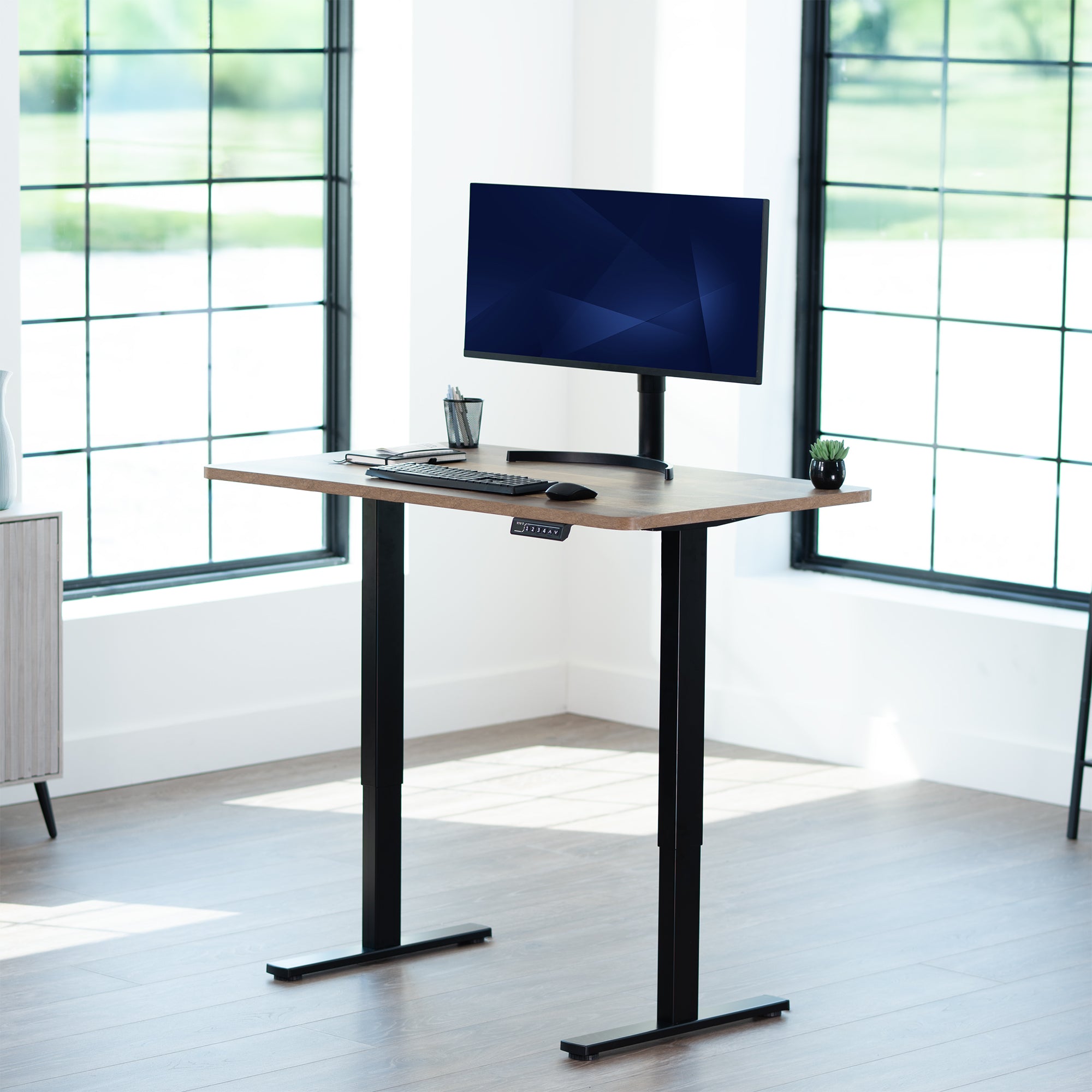 Sturdy ergonomic sit or stand active desk workstation with adjustable height using smart control panel.