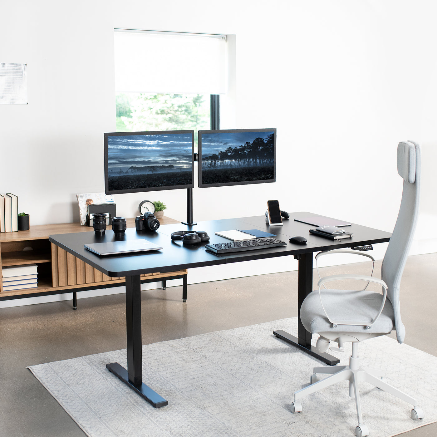 Minimalist office space with an electric sit-to-stand desk supporting a hefty weight.