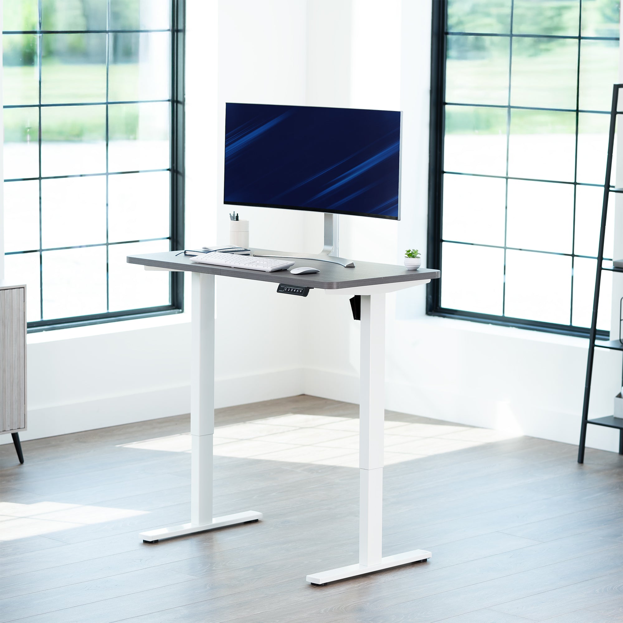 Sturdy ergonomic sit or stand active desk workstation with adjustable height using smart control panel.