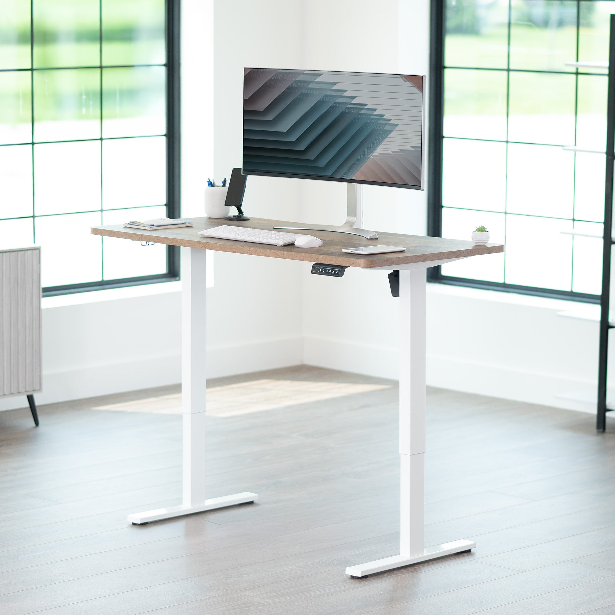 Sturdy ergonomic sit or stand active desk workstation with adjustable height using smart control panel.
