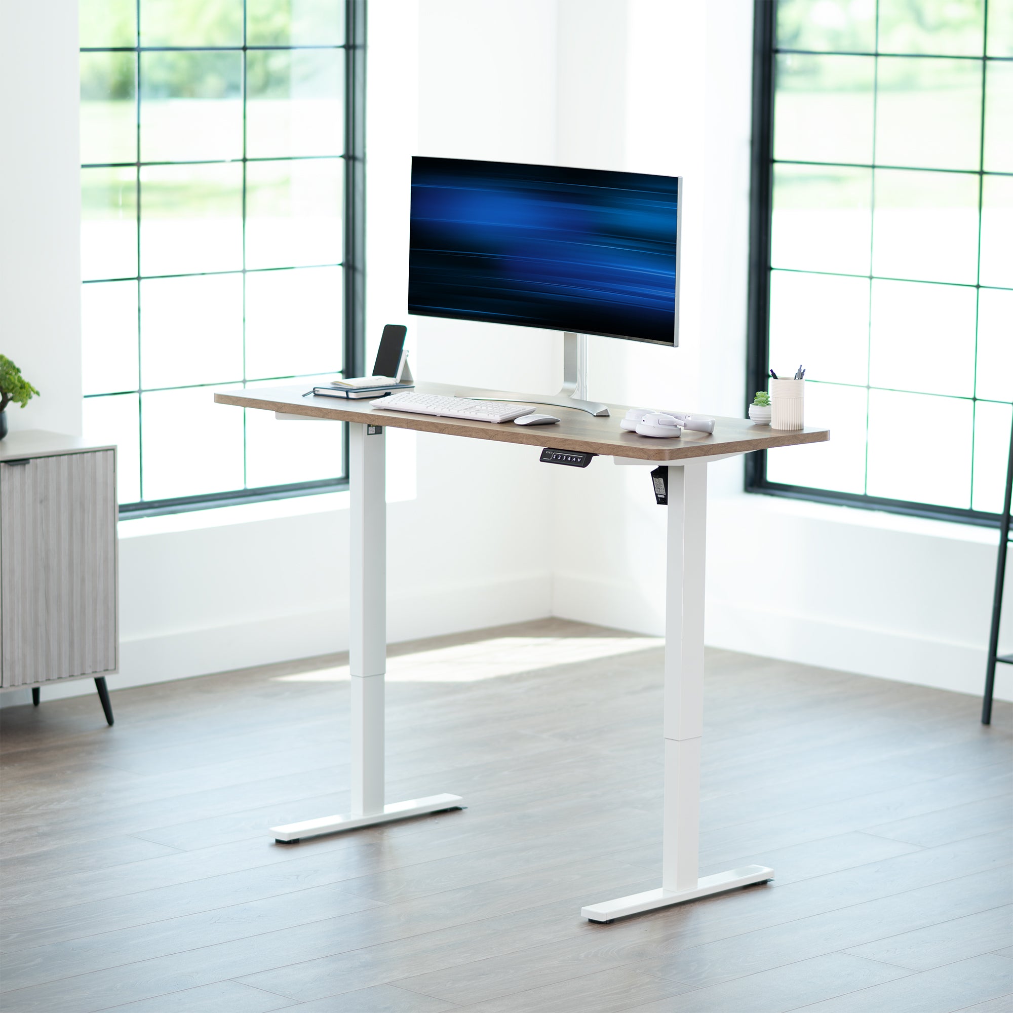 Sturdy ergonomic sit or stand active desk workstation with adjustable height using smart control panel.