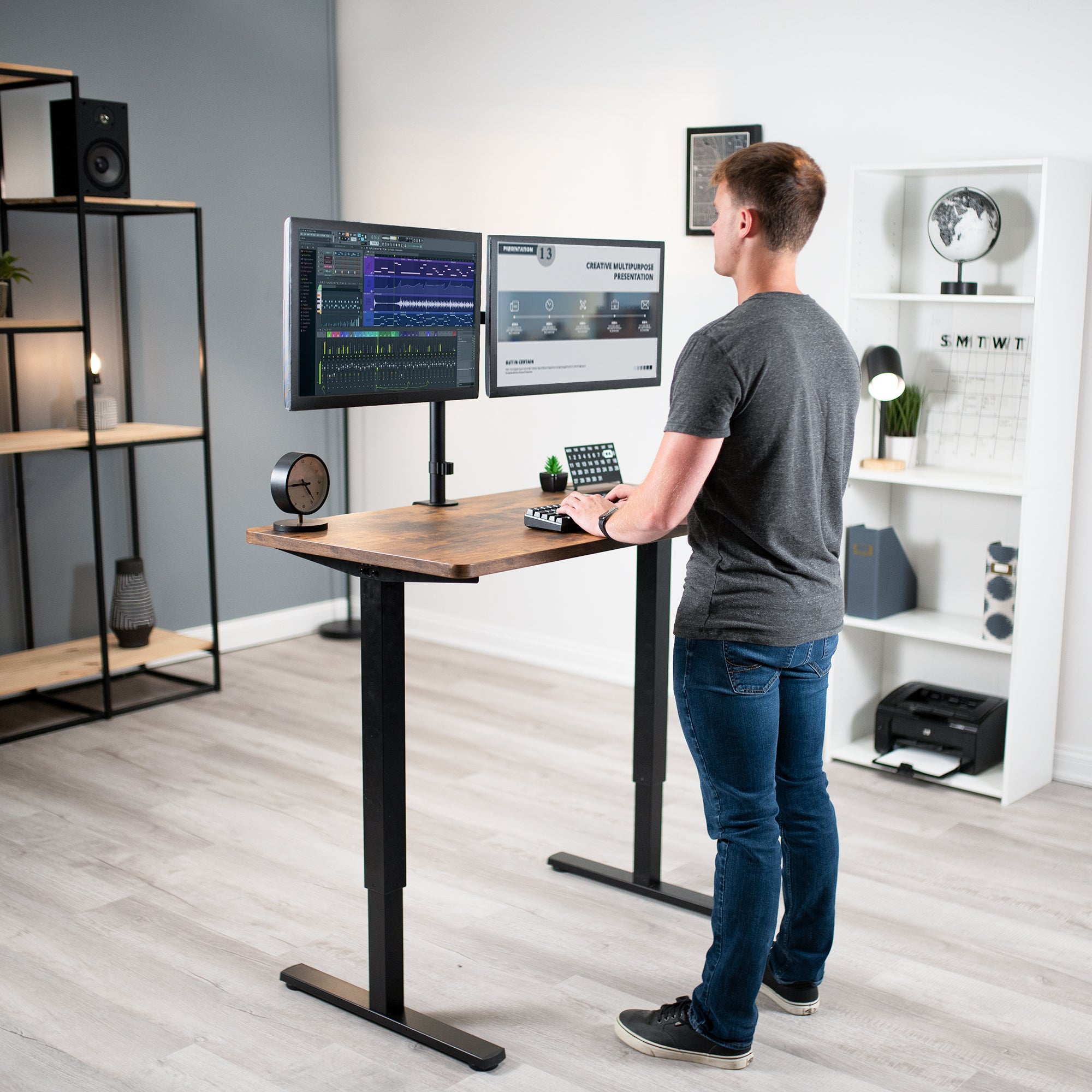 Compact steel desk frame with brown desktop and a dual monitor mount.