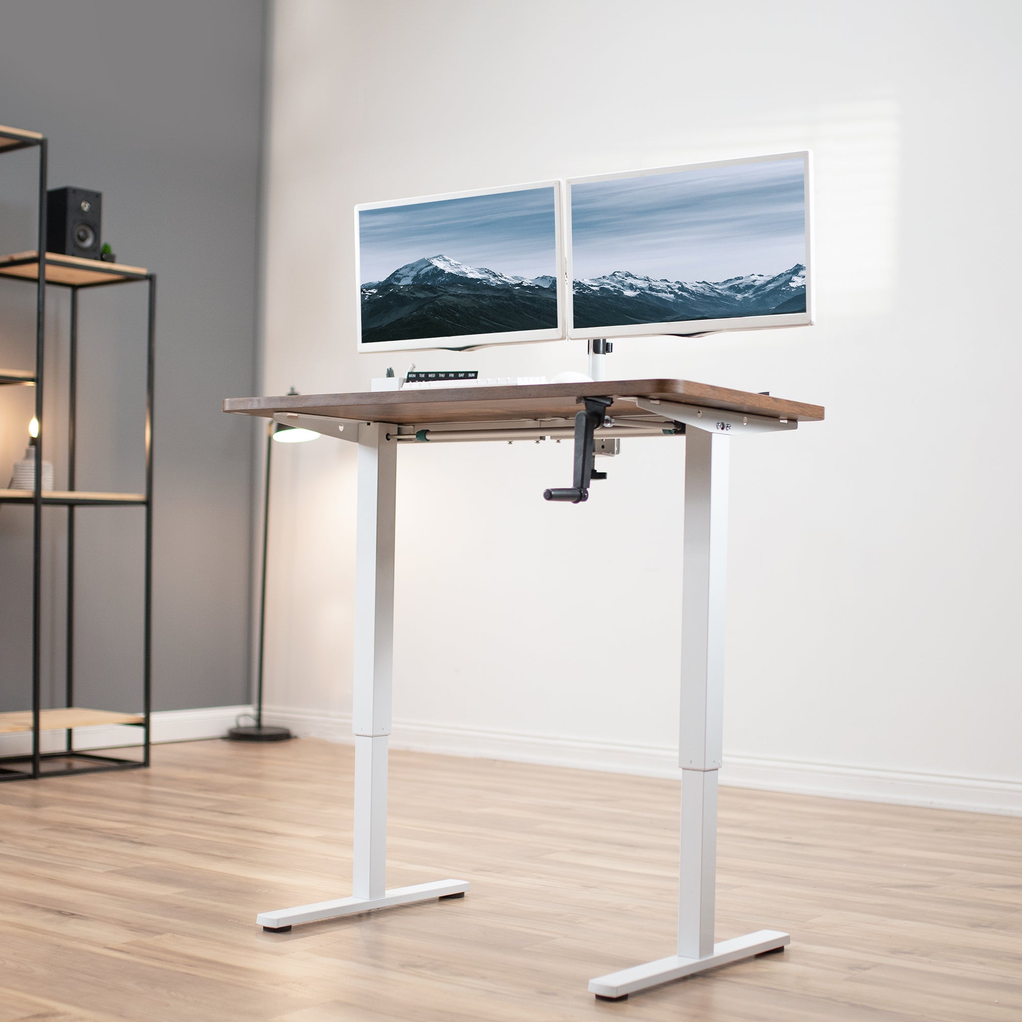 Compact steel desk frame with brown desktop and a dual monitor mount.