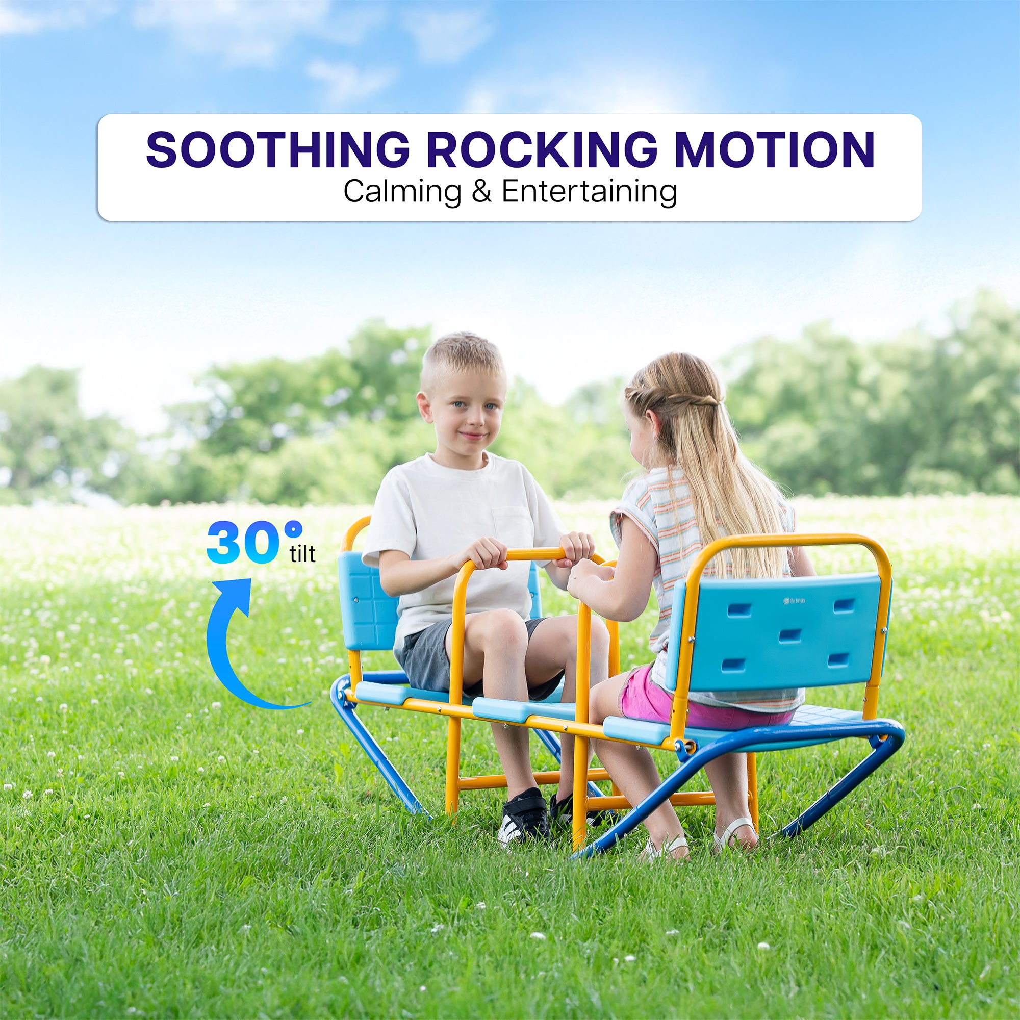 Two children sitting on a colorful rocking toy in a grassy field with a blue sky.