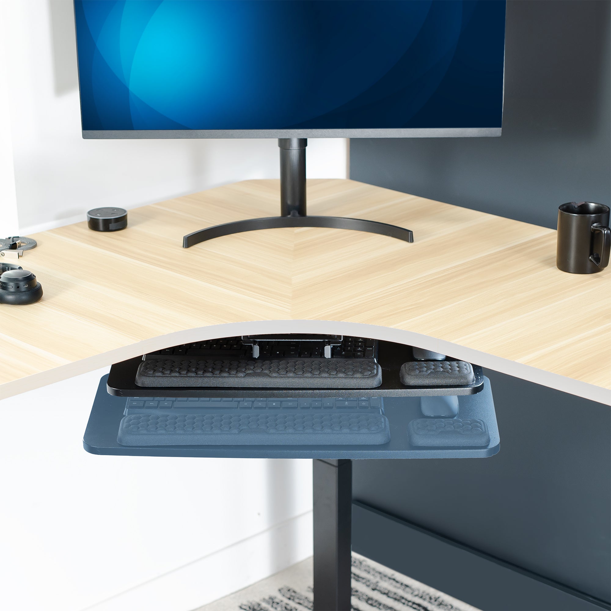 Hideaway under desk keyboard tray under a wooden desk.