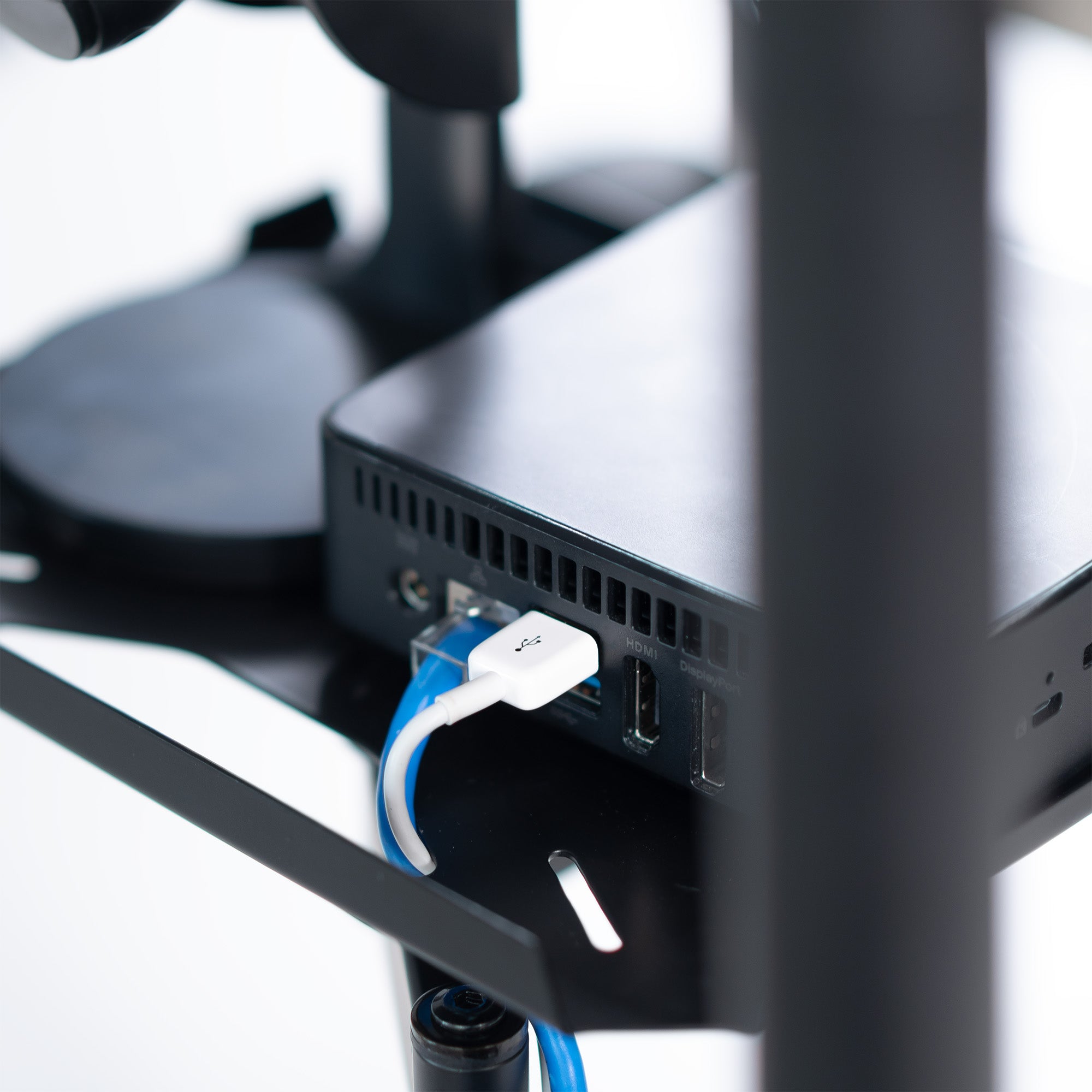 A black pole mount shelf with an articulating arm designed to attach to a pole.