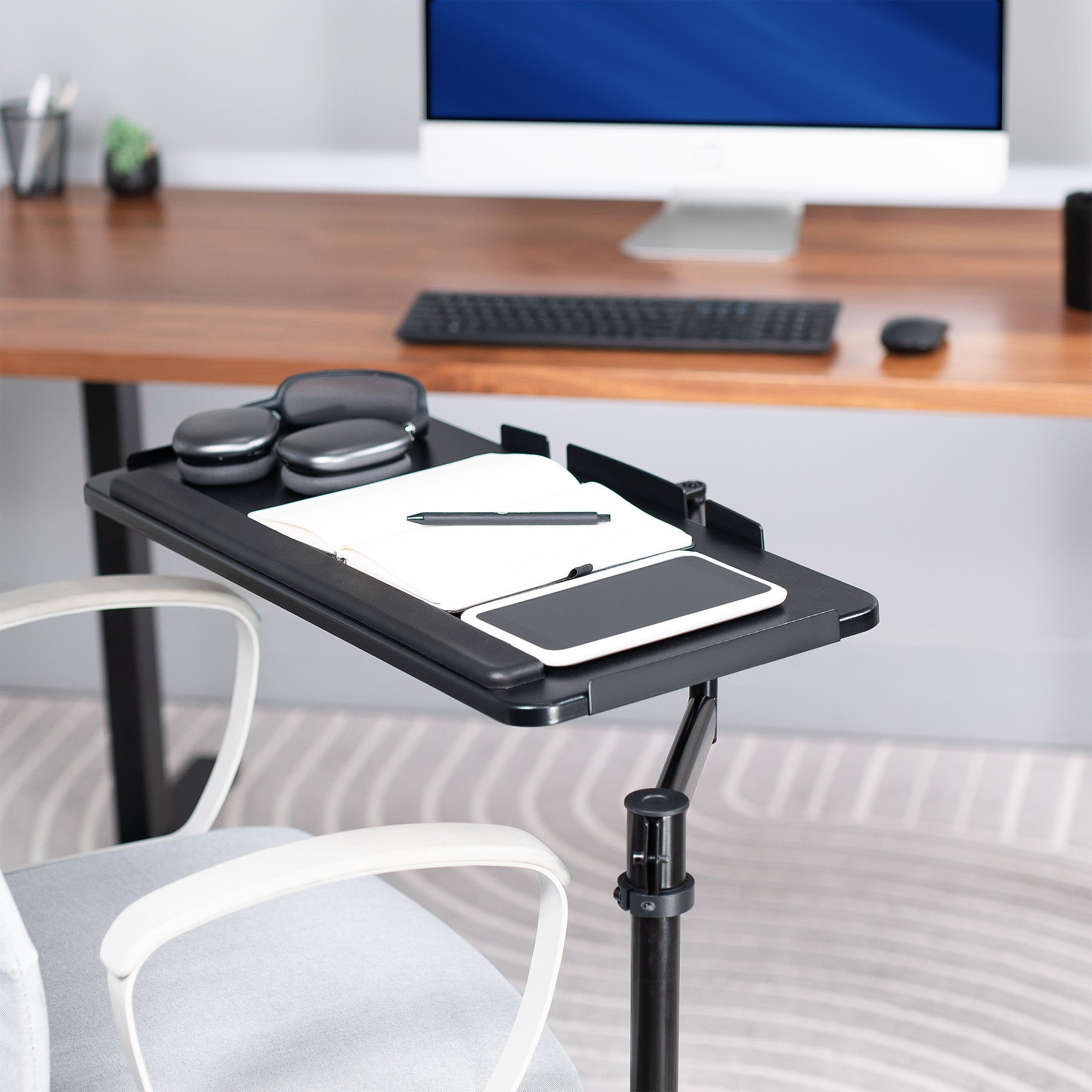 Office Chair Mounted Premium Keyboard Tray with desk accessories on it.