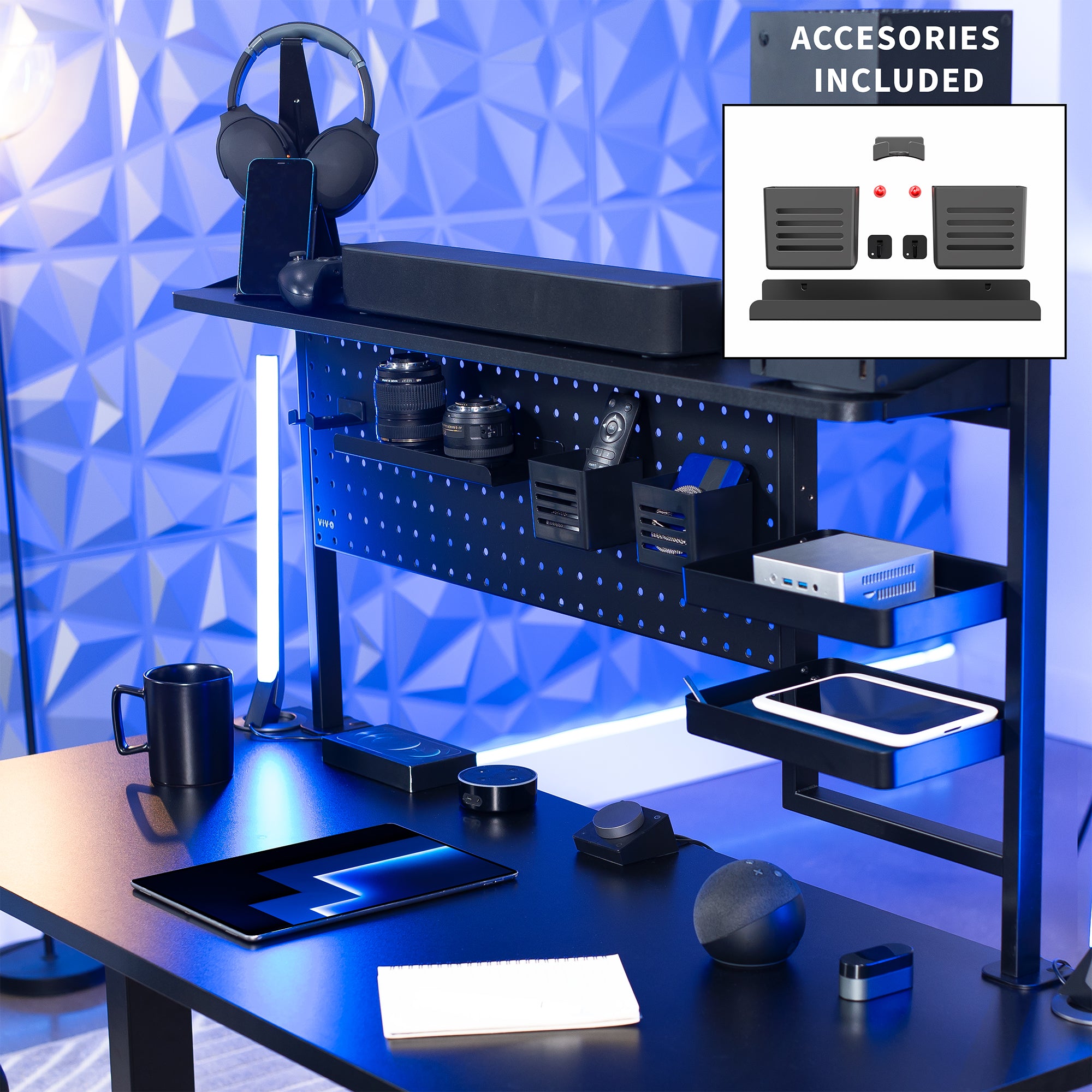 Gaming desk setup with accessories including a monitor, keyboard, mouse, and headset against a blue geometric wall.