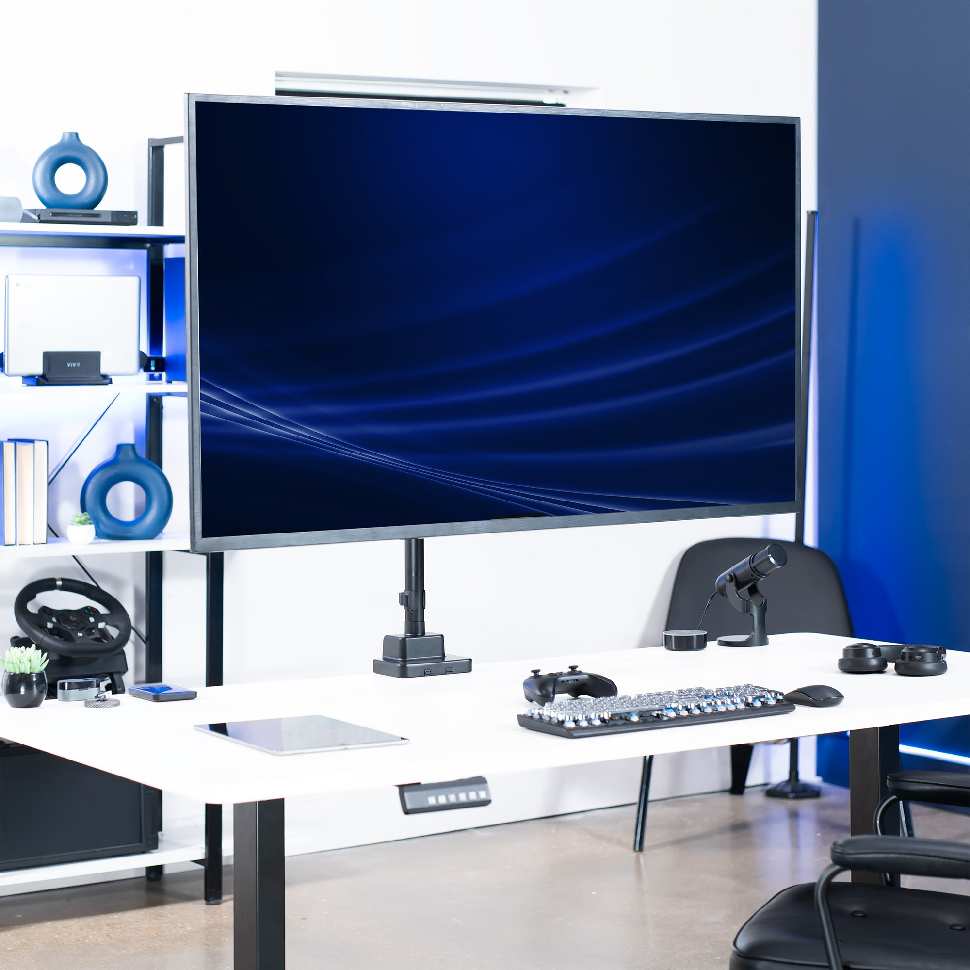 Single monitor mounted on a pneumatic arm desk mount in a modern office setting.