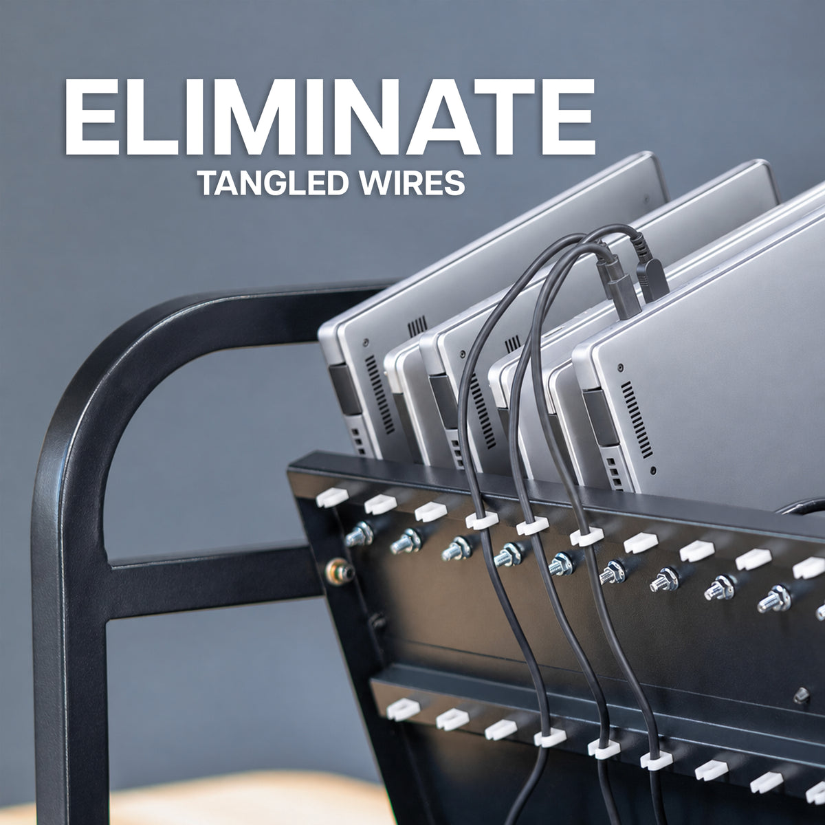 A close-up of a black laptop rack holding several silver laptops, with black cords routed through white ties. Large white text at the top reads 'ELIMINATE TANGLED WIRES' against a dark gray background.