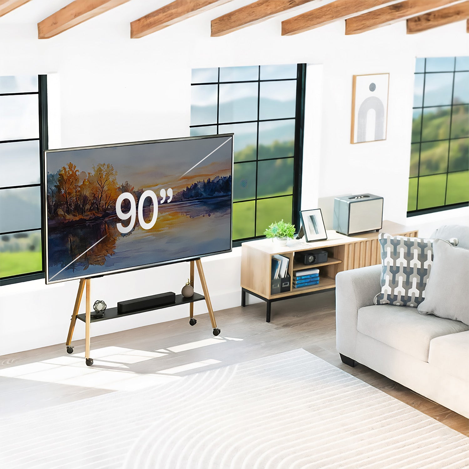 Modern living room with a large TV displaying '90”, white sofa, and wooden floor.