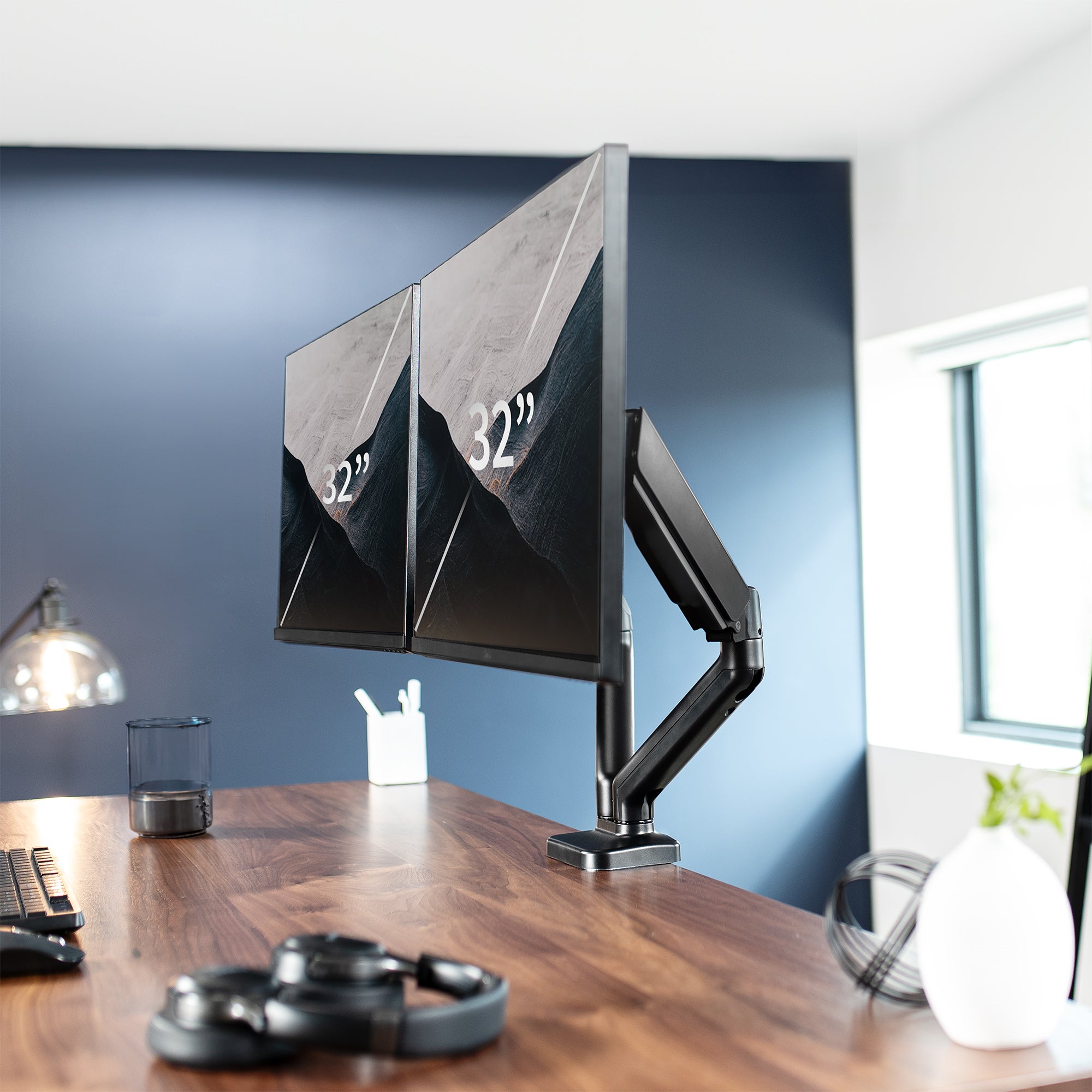 Sturdy adjustable mechanical arm dual monitor ergonomic desk stand for office workstation.