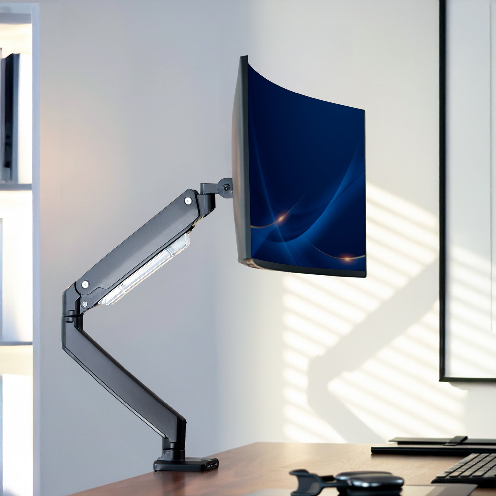 Pneumatic Arm Single Monitor Desk Mount with USB on desk in office setting.