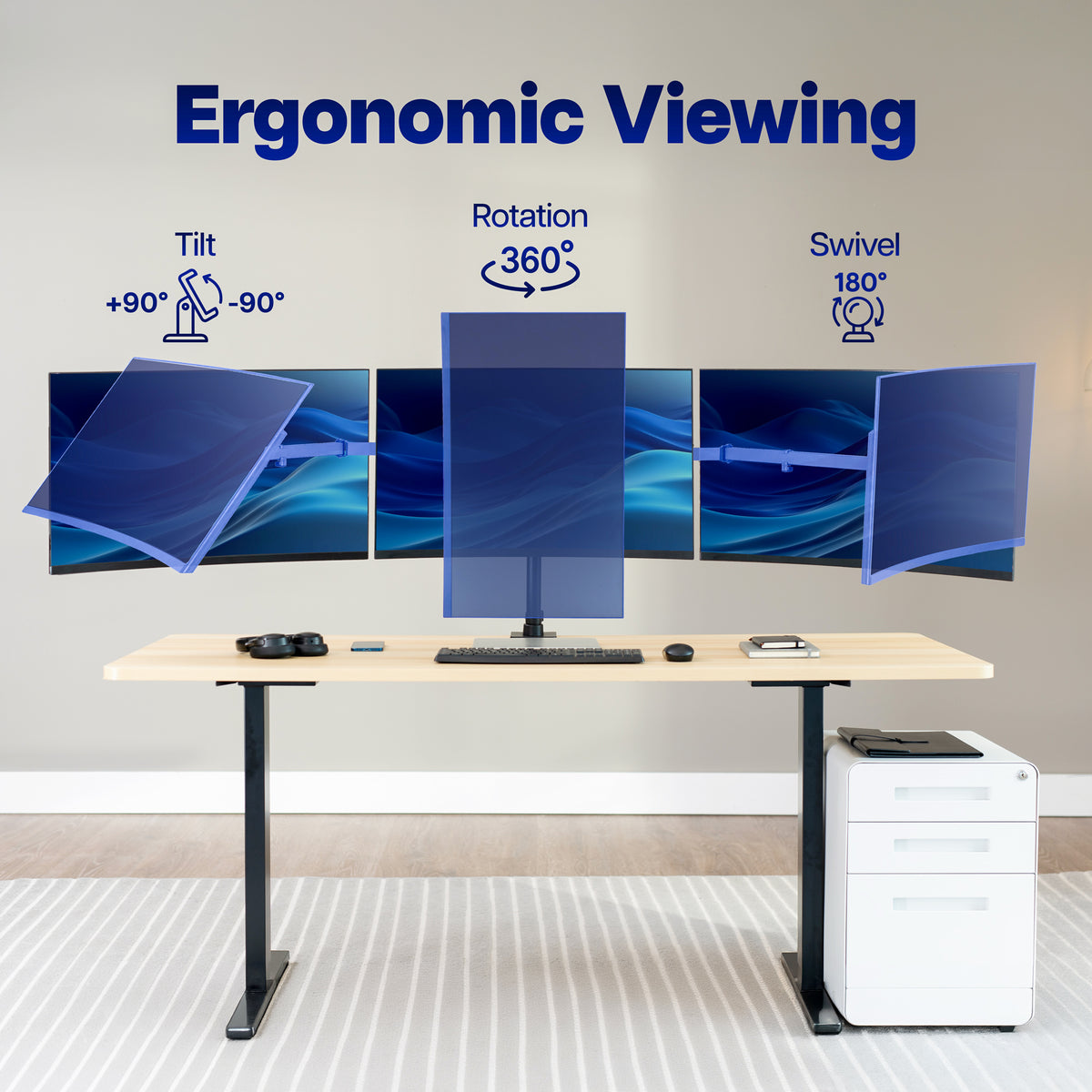 An ergonomic desk setup with multiple monitor screens arranged in a curved wall display, labeled with text and icons for tilt, rotation, and swivel. The desk has a light wood top and black legs, with a white filing cabinet beside it, set against a neutral indoor background.