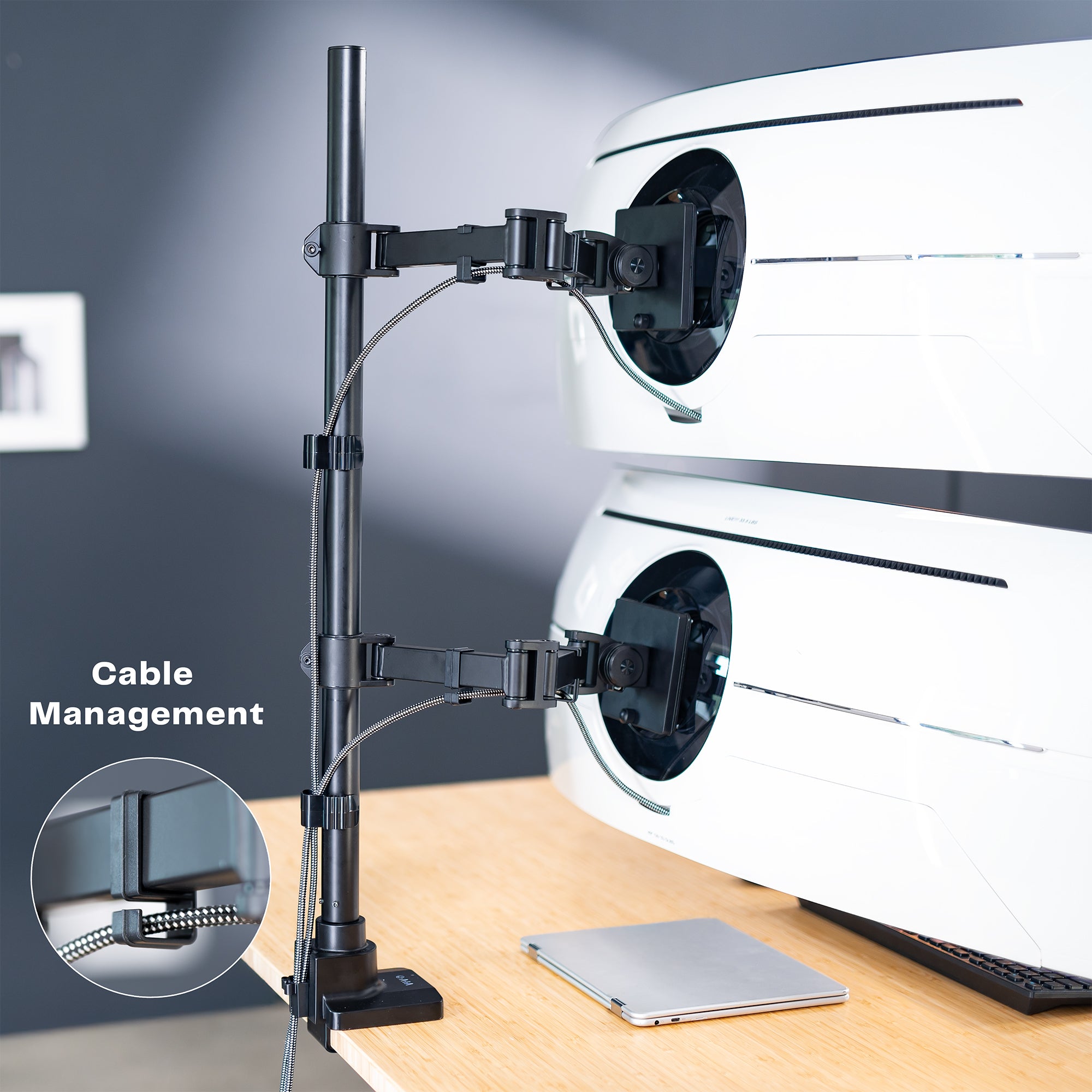 Computer monitor stand with cable management feature on a desk.
