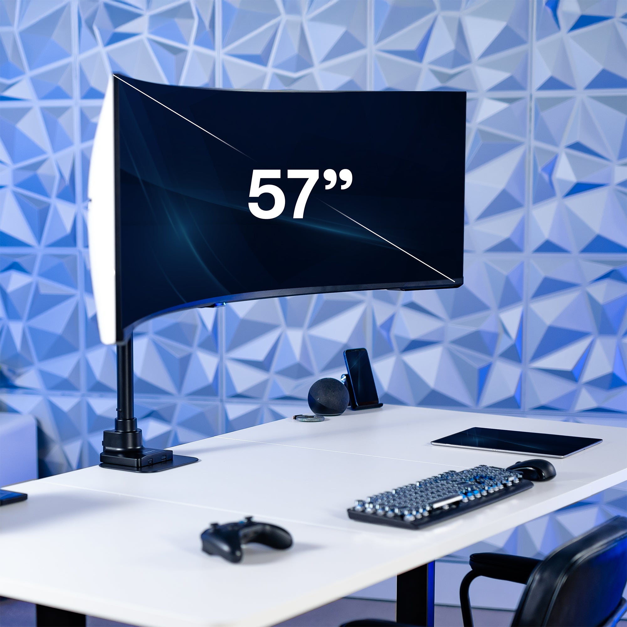 57-inch monitor on a desk with a geometric blue wall background