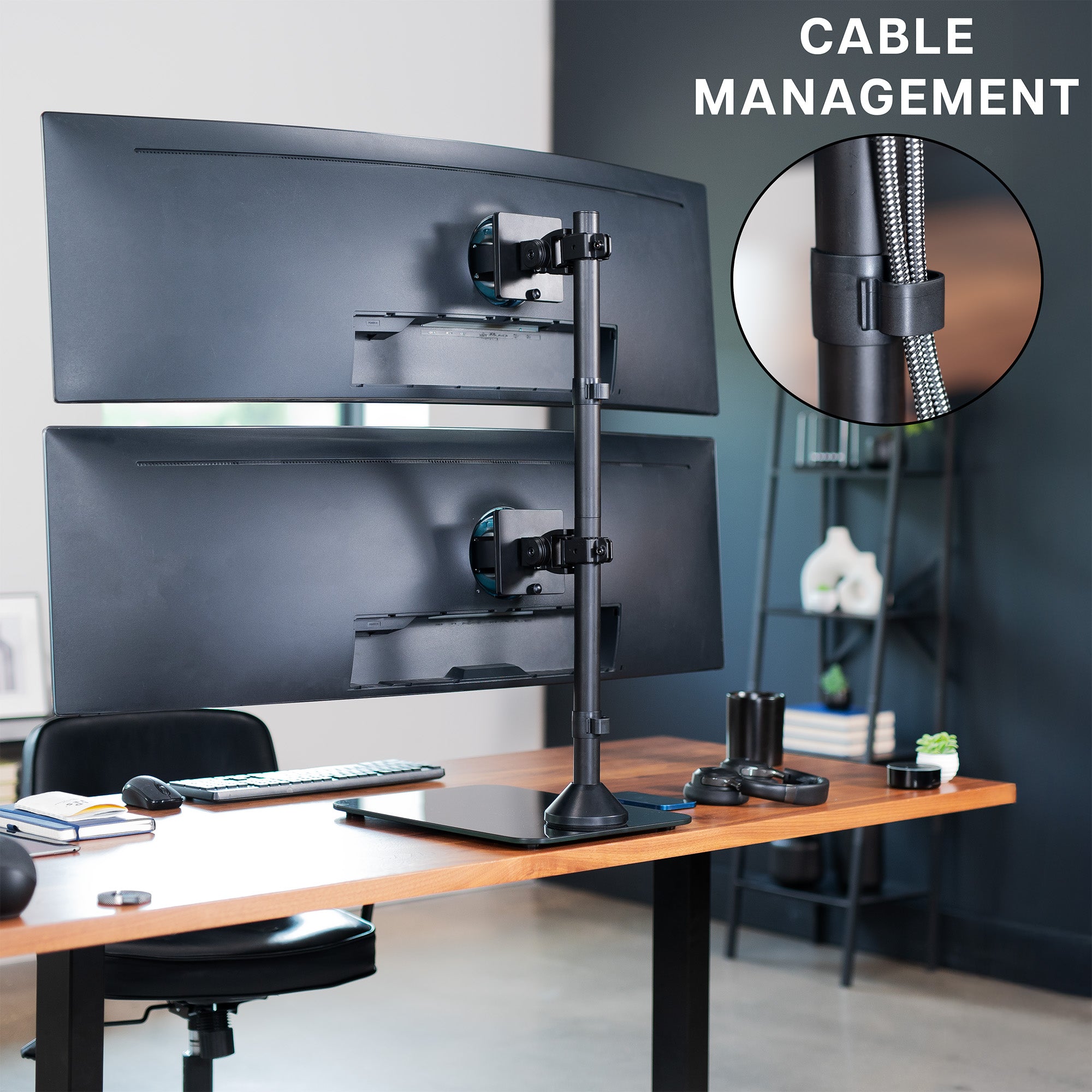 Desk setup with dual monitor stand and cable management feature, office or home office setting.