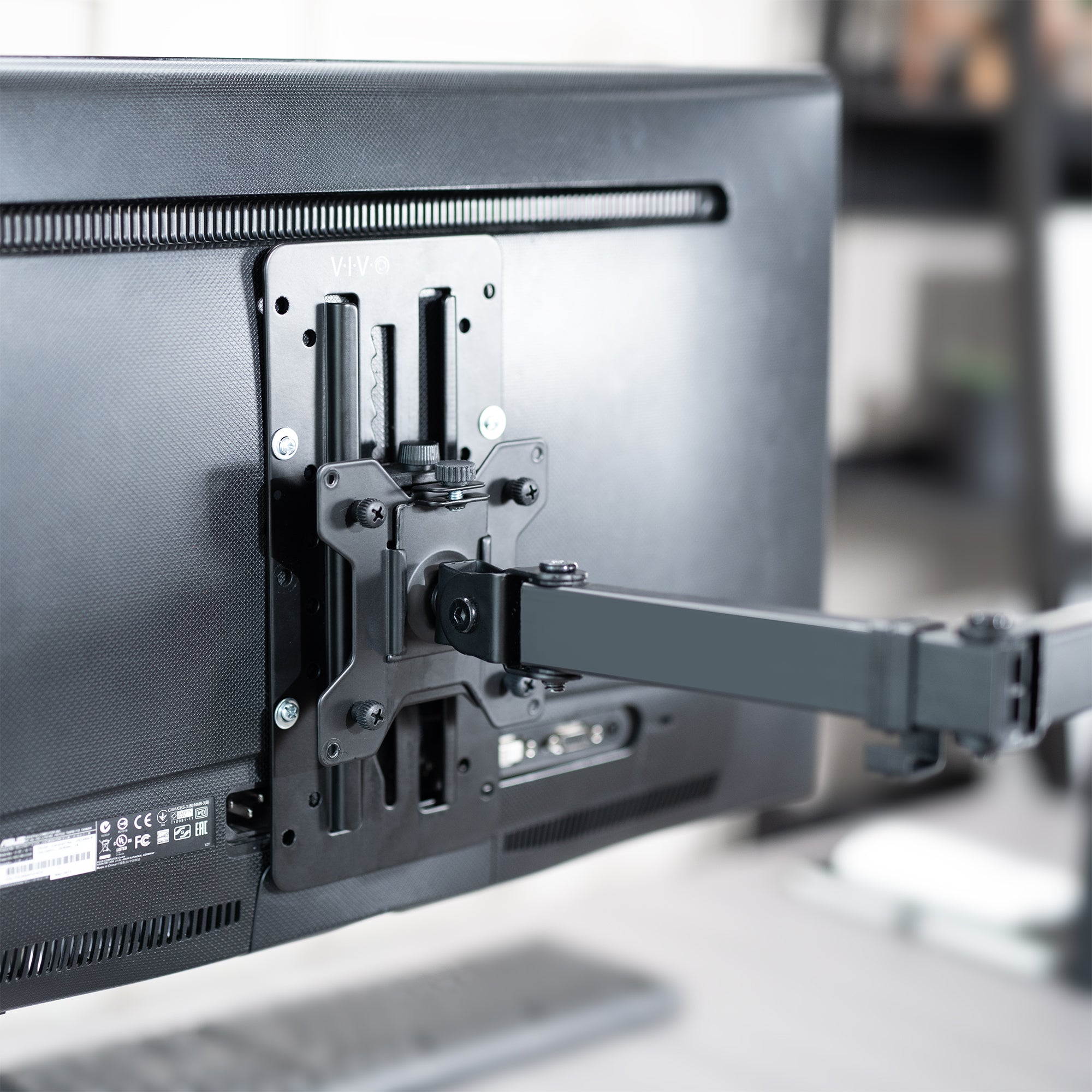 Monitor with a swivel arm attached, showing the mounting bracket.