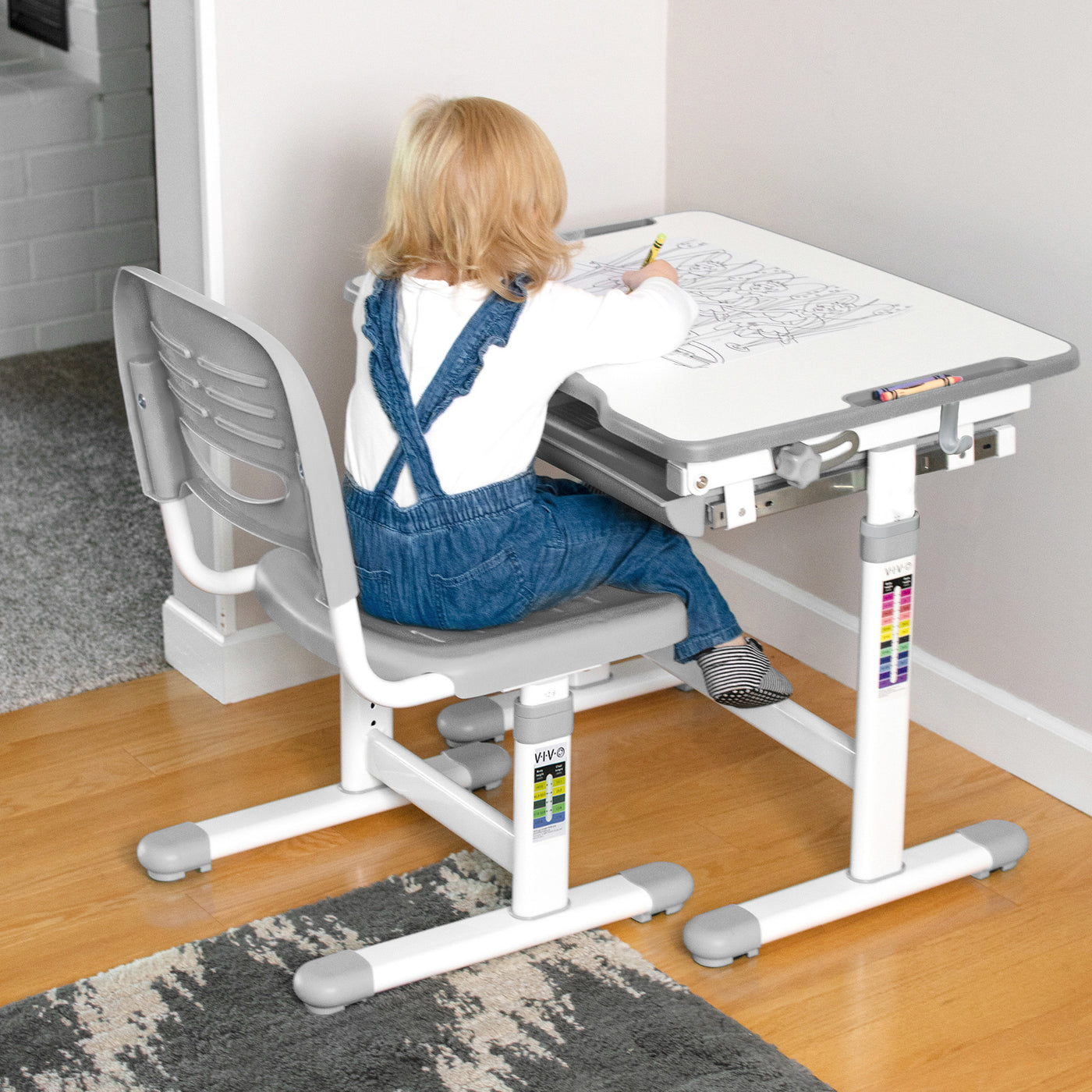 At home children's desk and chairs are being used as an art space for coloring.