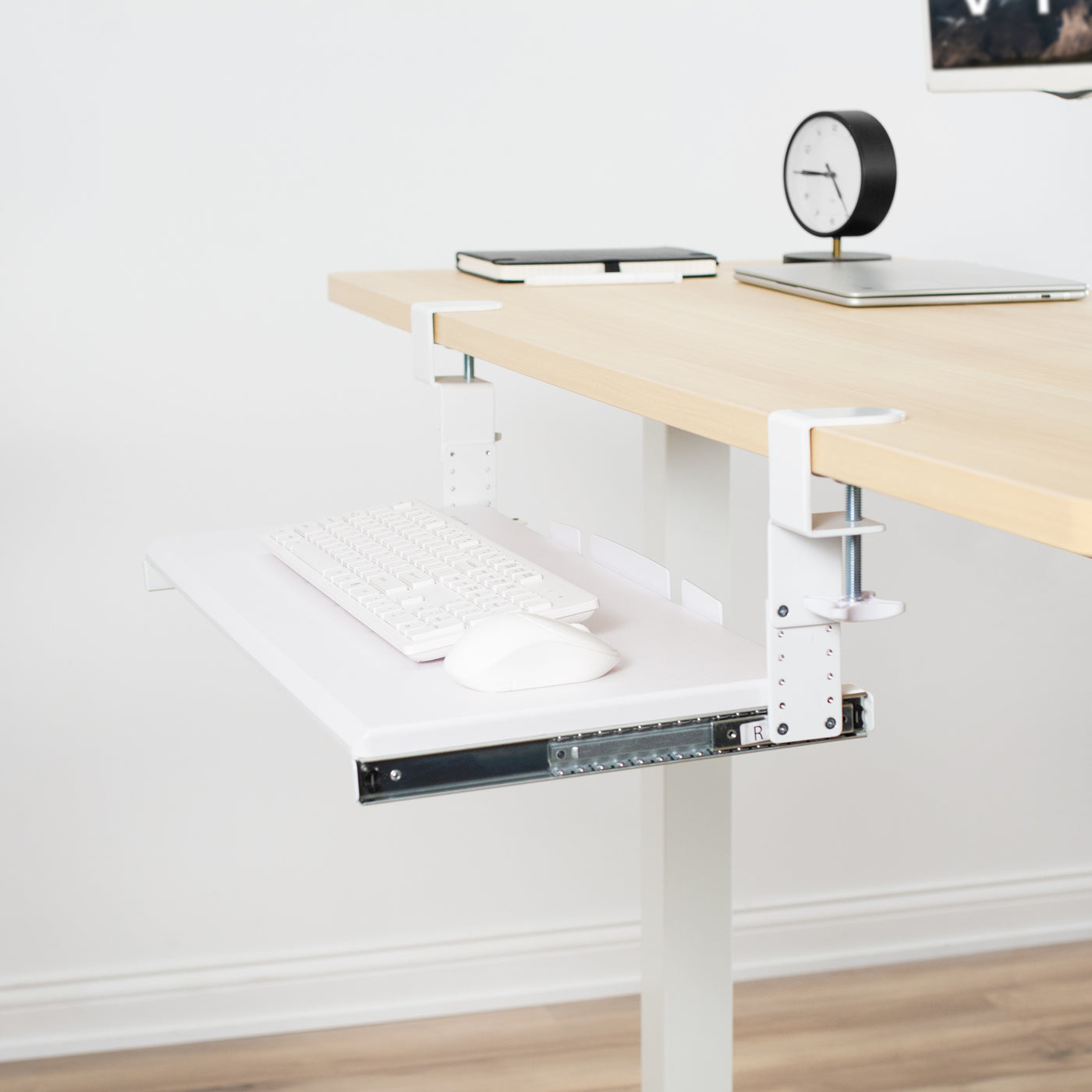 White under-desk keyboard tray with added height adjustment brackets.