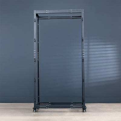 Black metal server rack against a gray wall