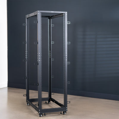 Black metal server rack against a dark gray wall