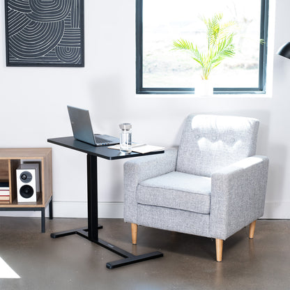 Mobile laptop cart by chair in home office space