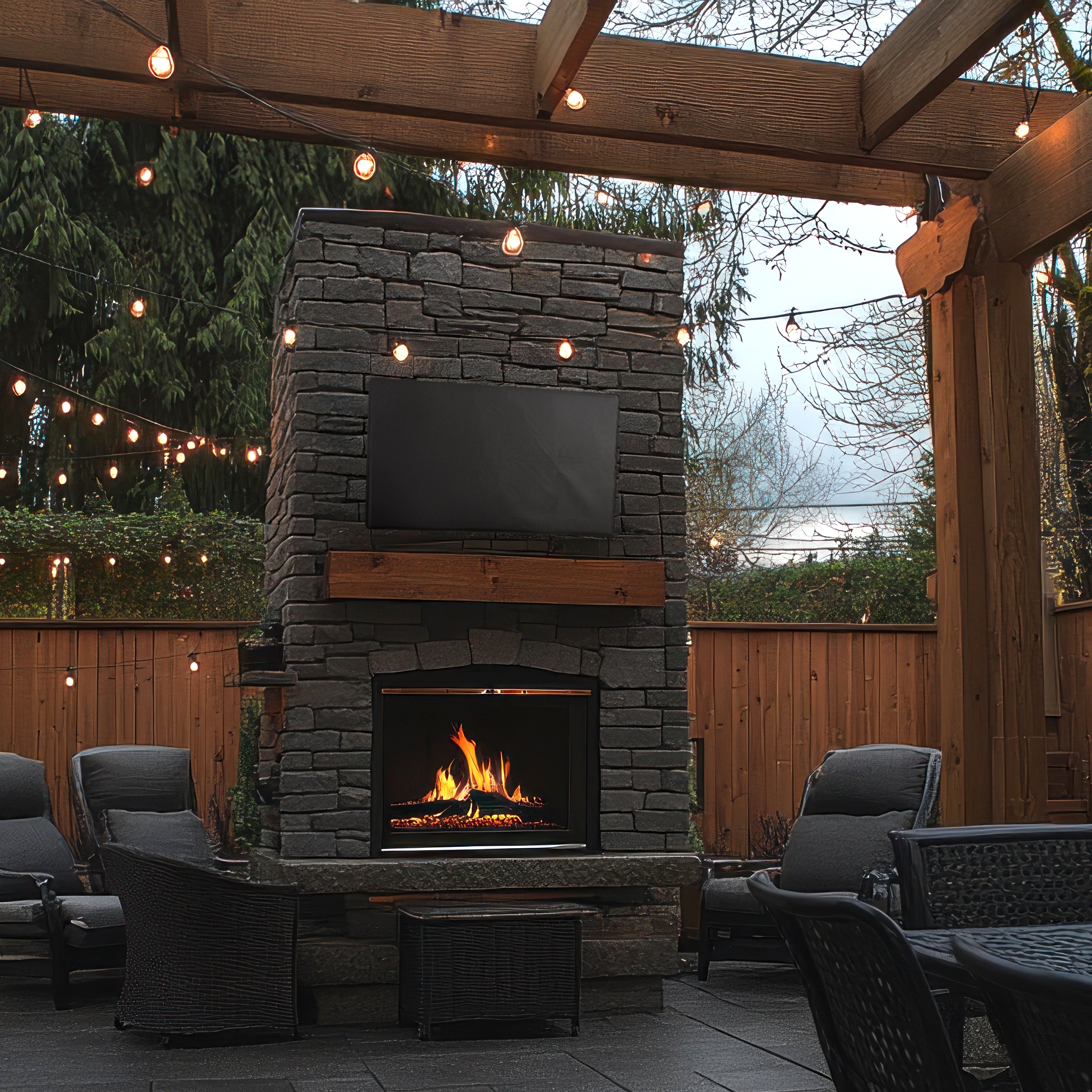 TV with cover on stone fireplace in outdoor patio.