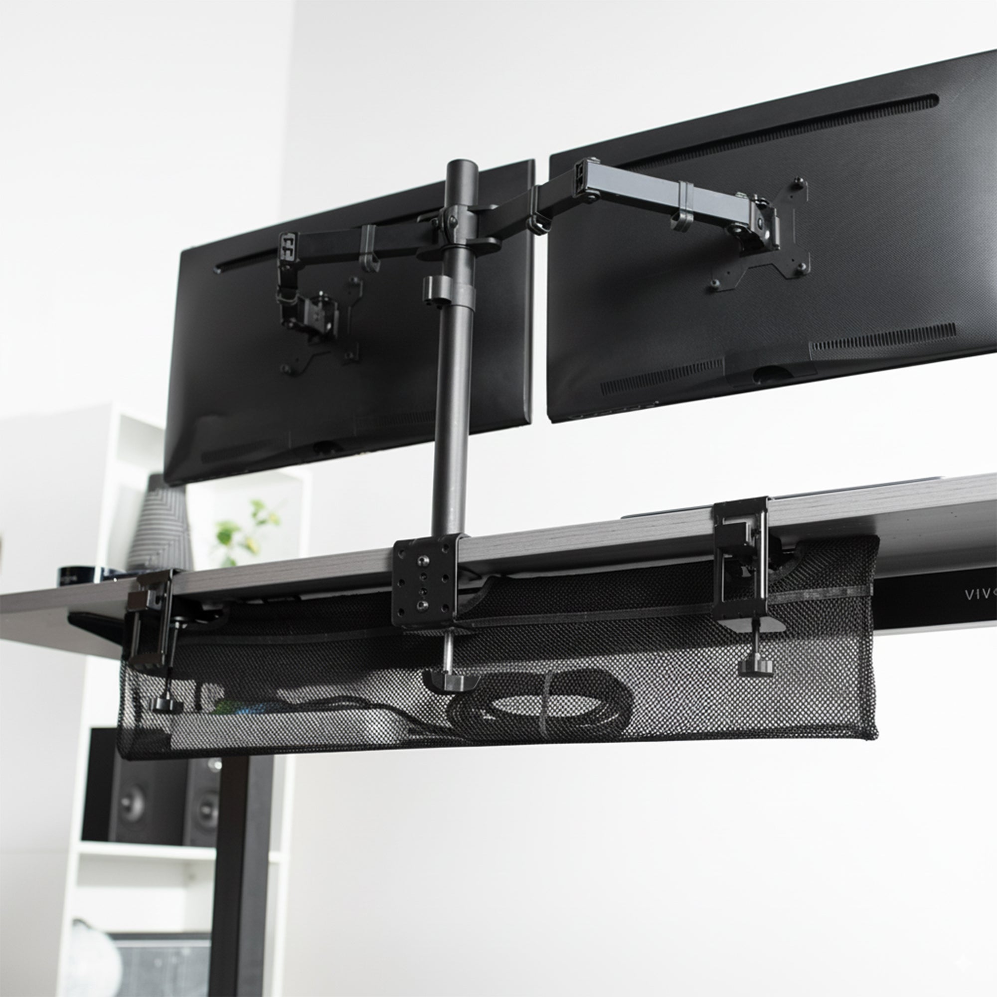 Cable management net under clamp on dual monitor mount to easily guide cords out of the way.