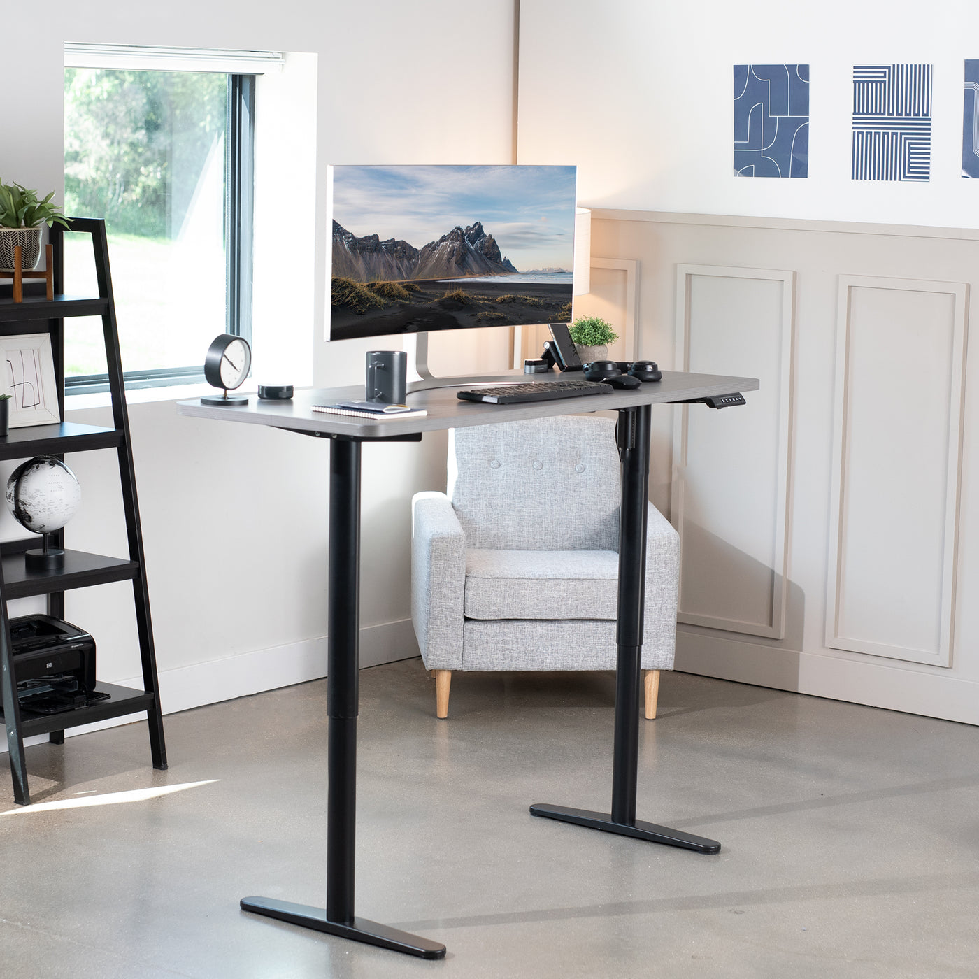 Ergonomic sit or stand desk frame in a fully furnished office space.