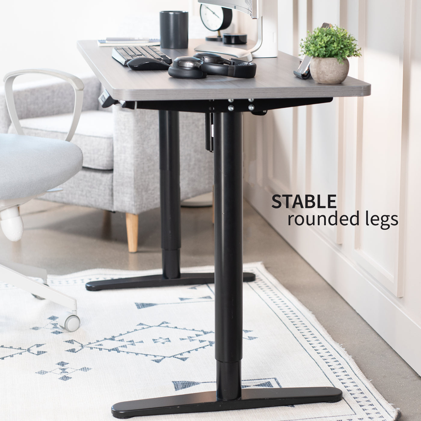 Sturdy sit-to-stand electric desk frame with a smart controller panel.