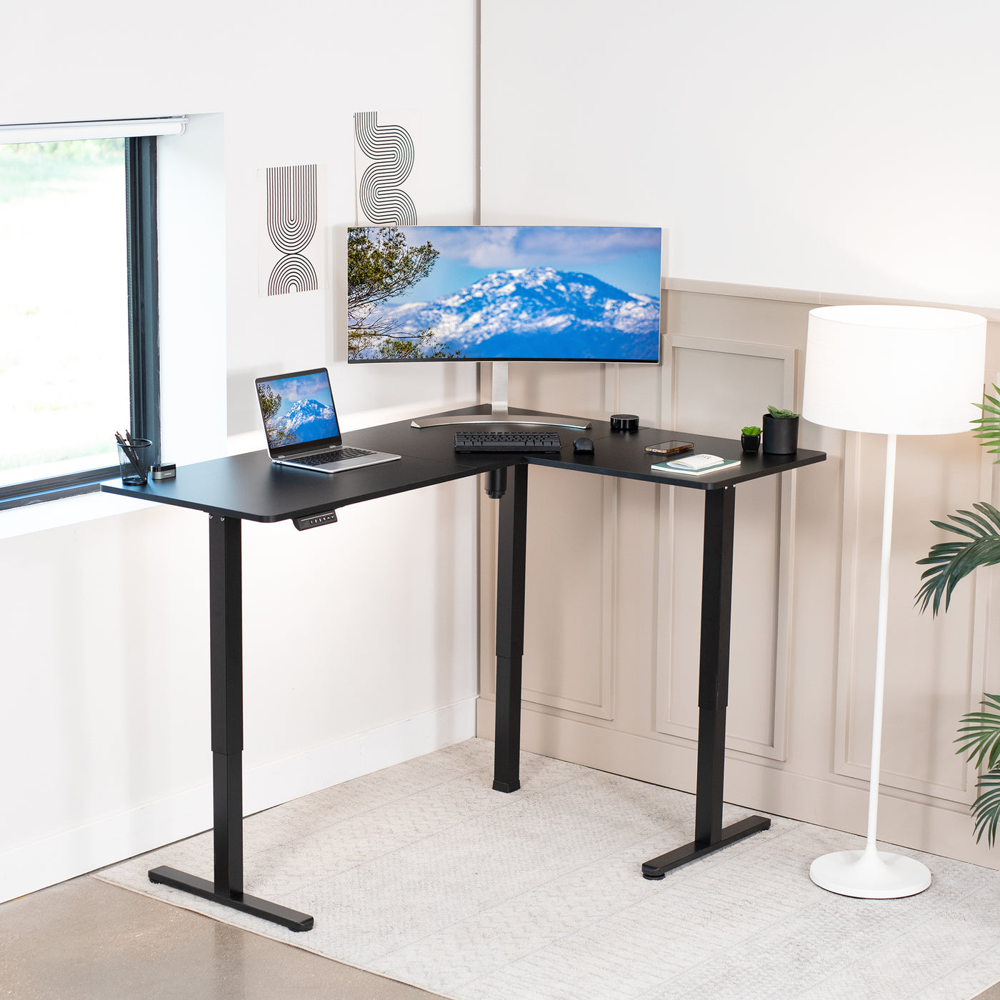 Heavy duty electric sit-to-stand L-shaped desk.