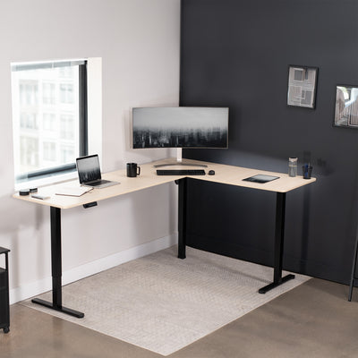 Electric heavy-duty large corner desk workstation for modern office workspaces.