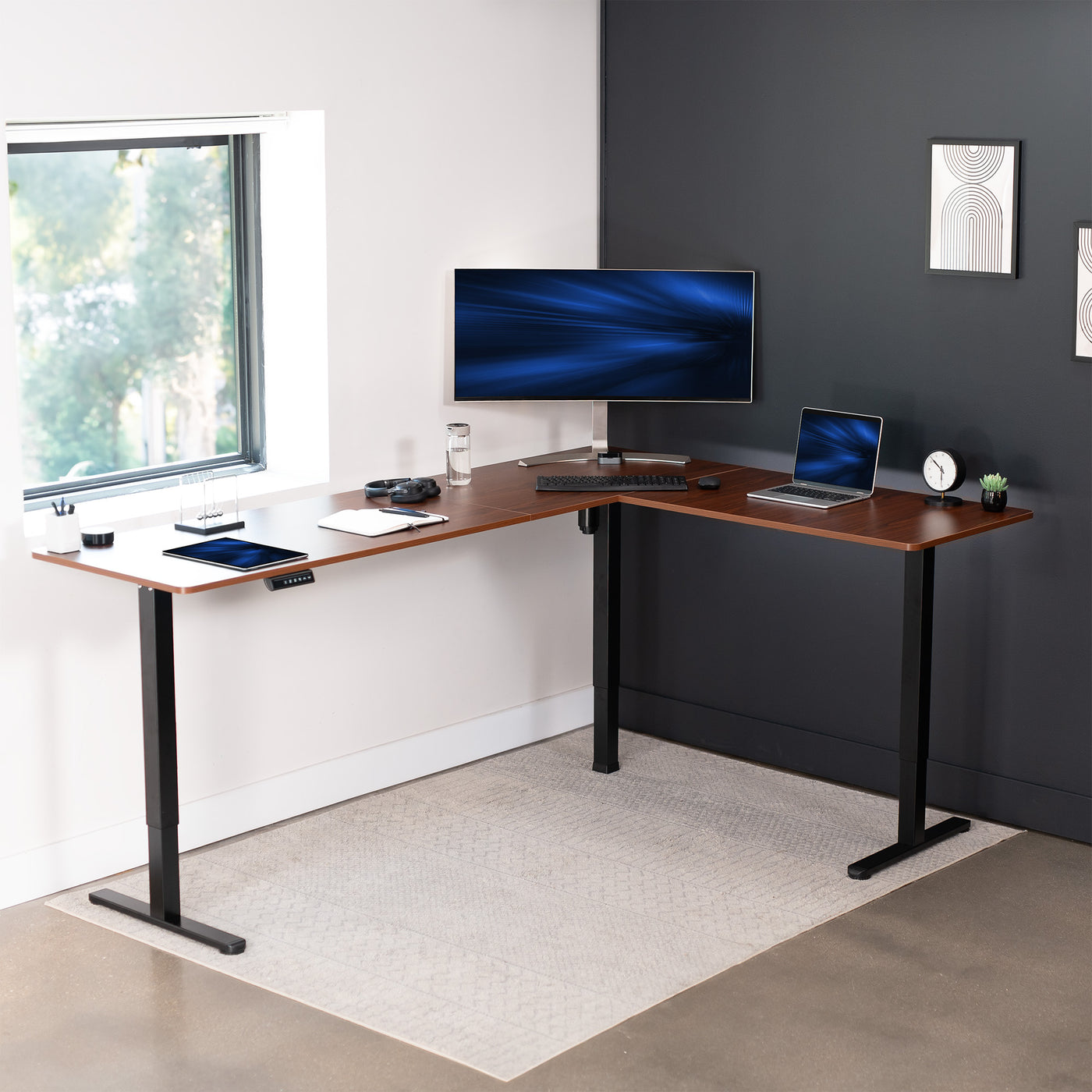 Electric heavy-duty large corner desk workstation for modern office workspaces.