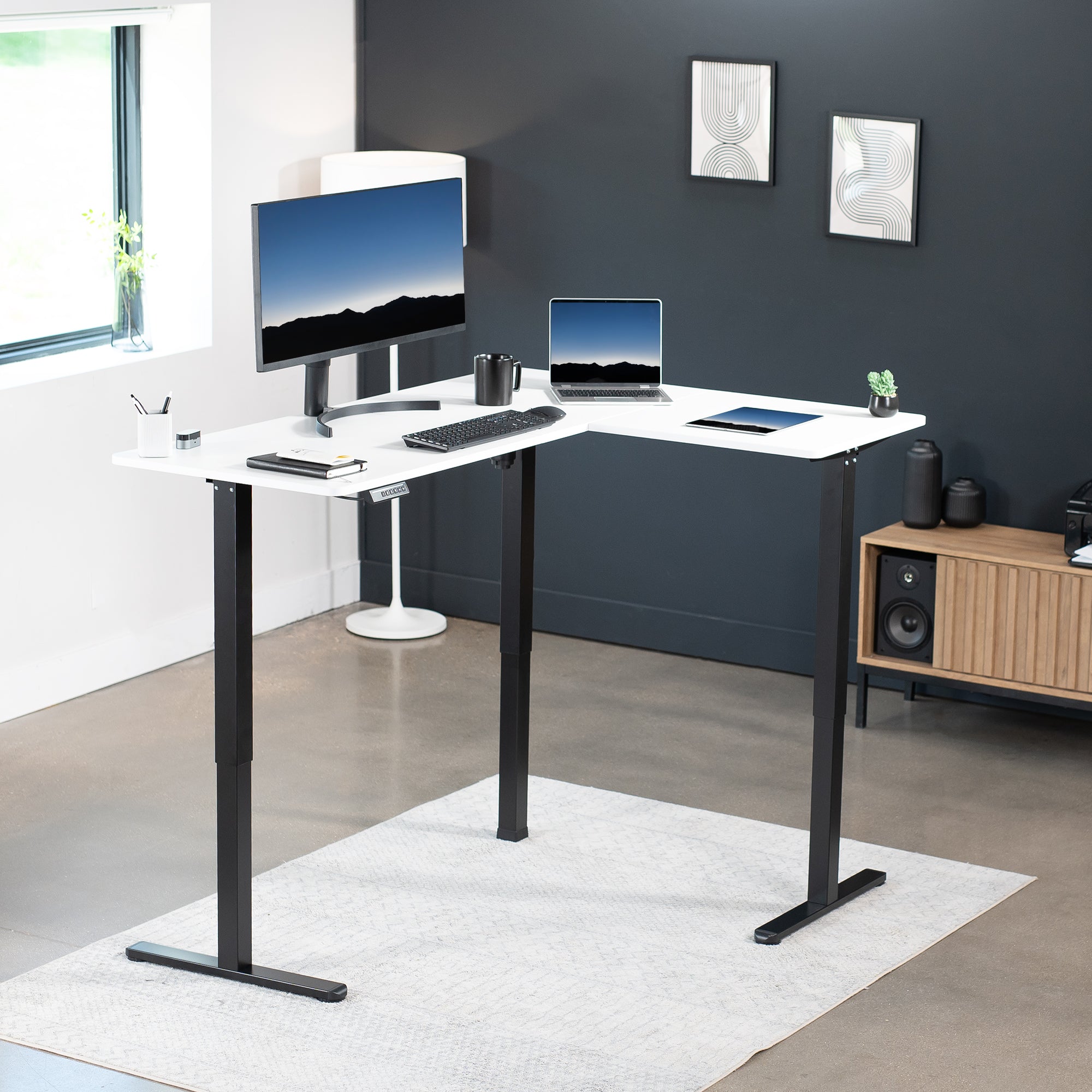 Electric heavy-duty corner desk workstation for modern office workspaces.