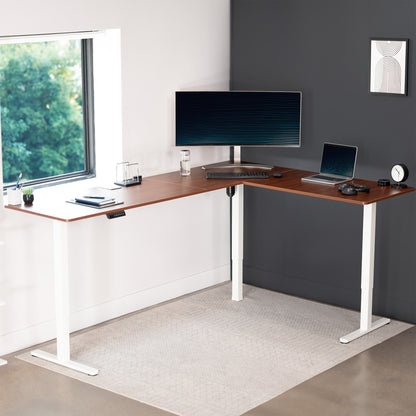 Electric heavy-duty large corner desk workstation for modern office workspaces.