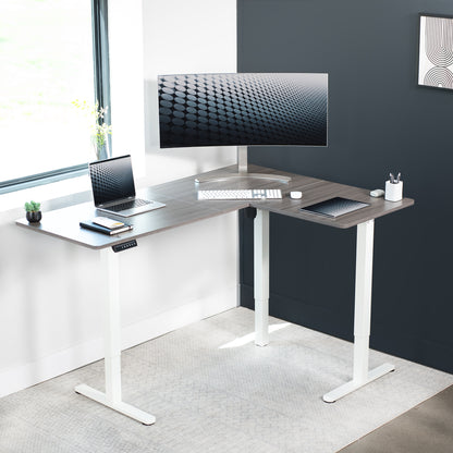 Electric heavy-duty corner desk workstation for modern office workspaces.