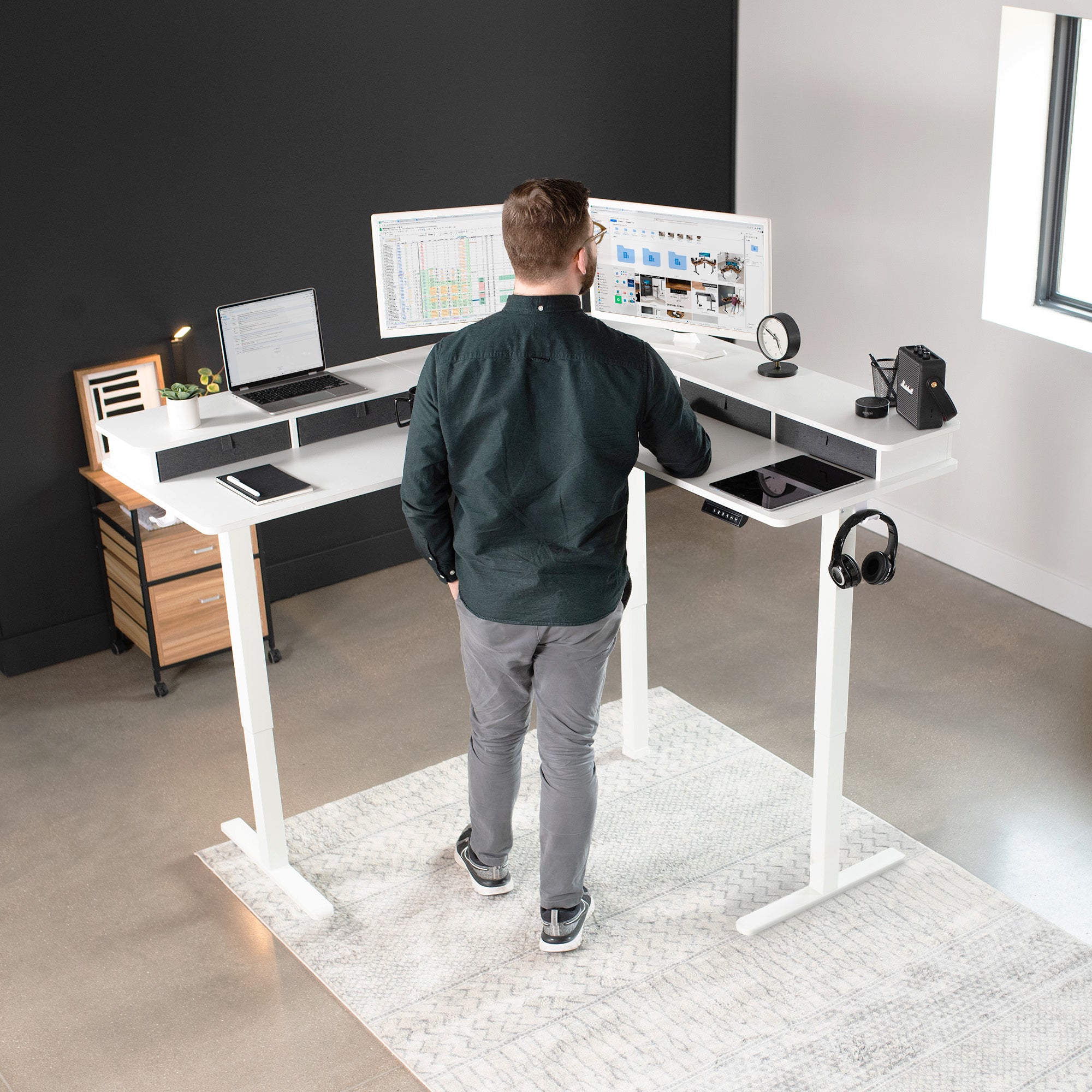 Spacious workstation surface with built-in shelving supporting multiple monitors.