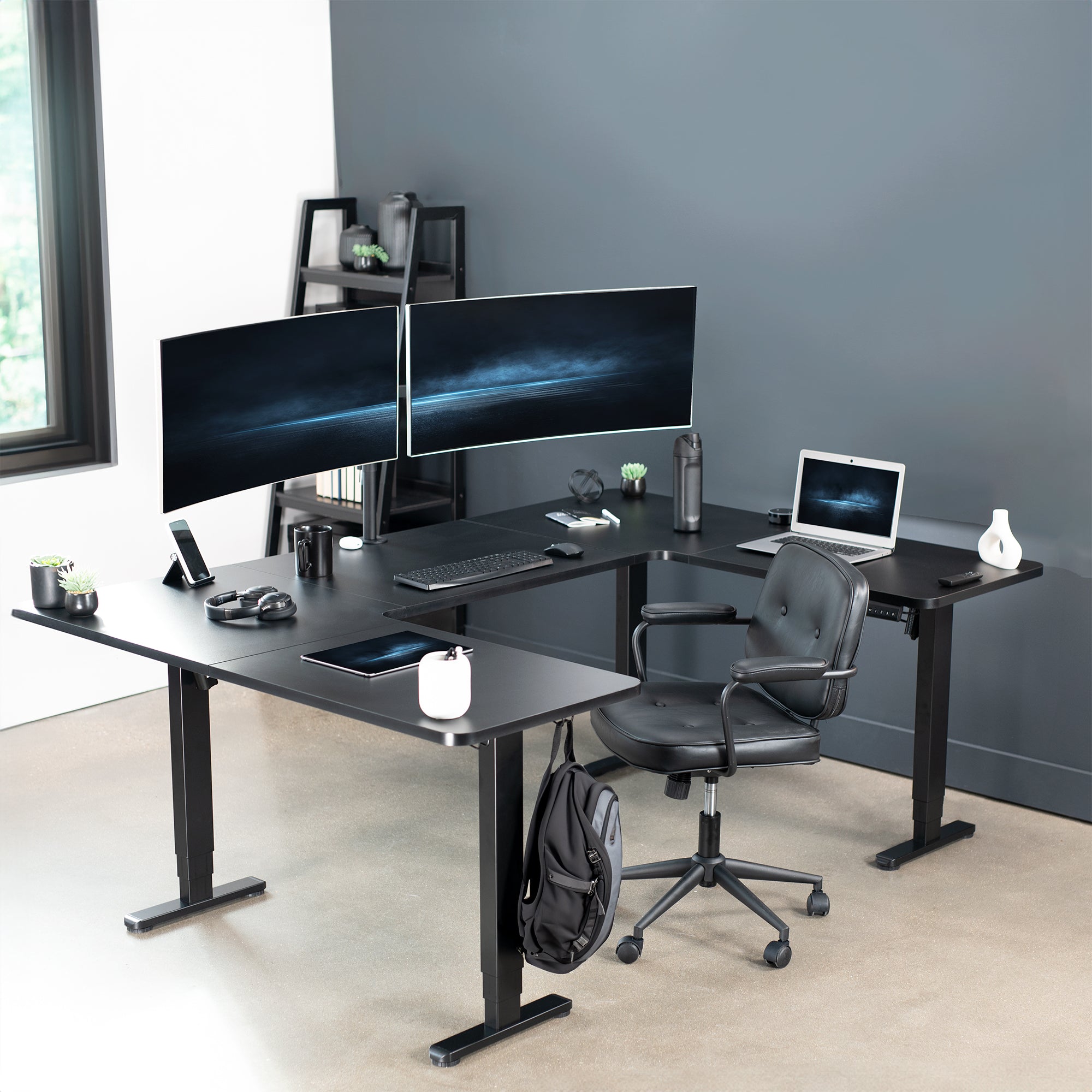 Heavy-duty spacious height adjustable U-shaped electric desk with programmable memory controller.