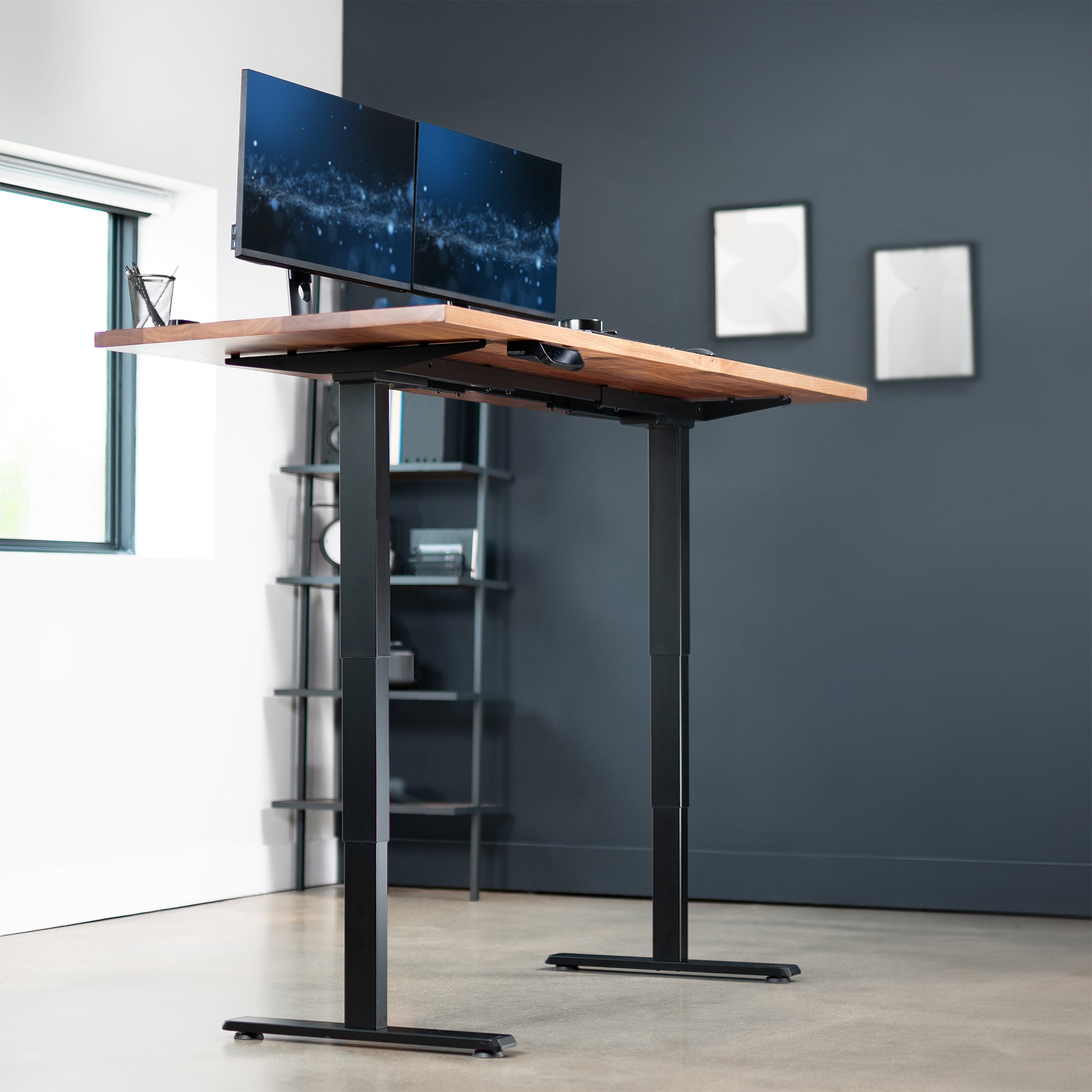 Under side of electric height adjustable dual motor desk frame in home office. 