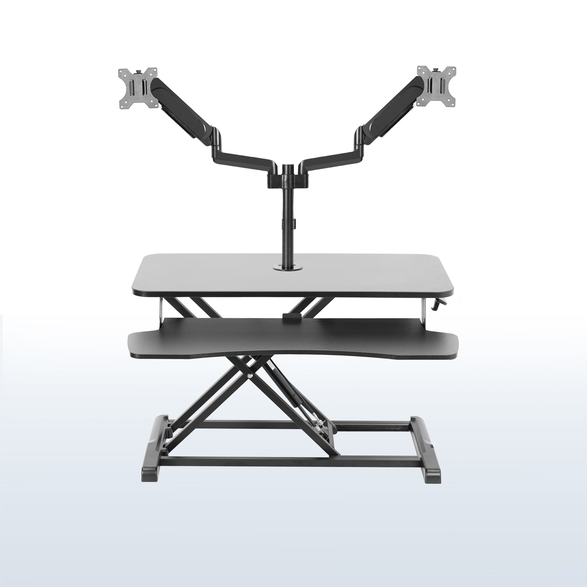 Height adjustable desk riser with articulating pneumatic dual monitor mount.