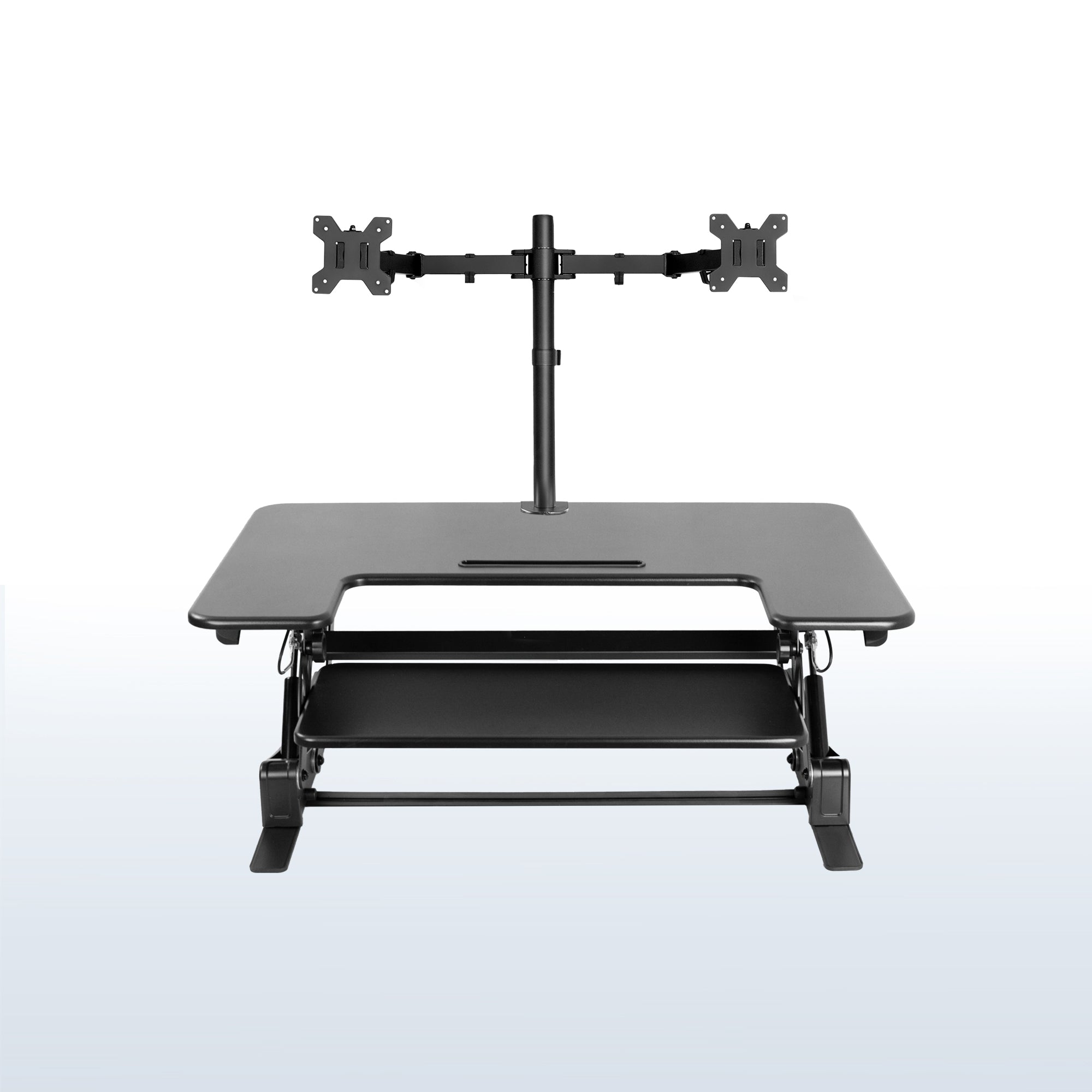 Height adjustable desk riser with articulating dual monitor mount.