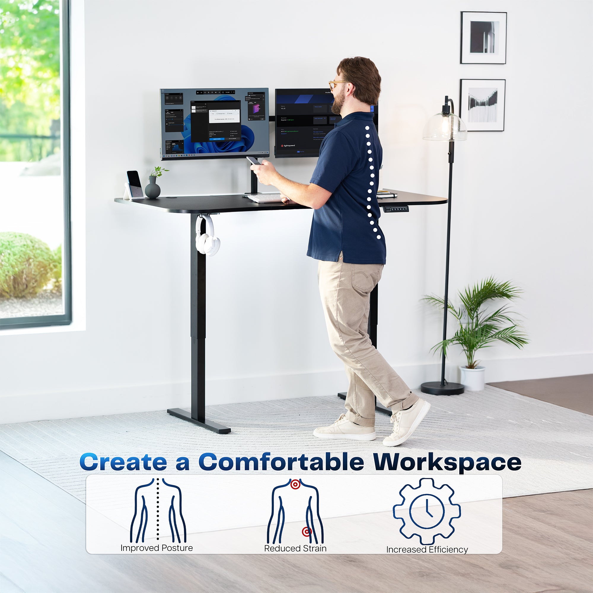 Model standing at height adjustable desk in office space.