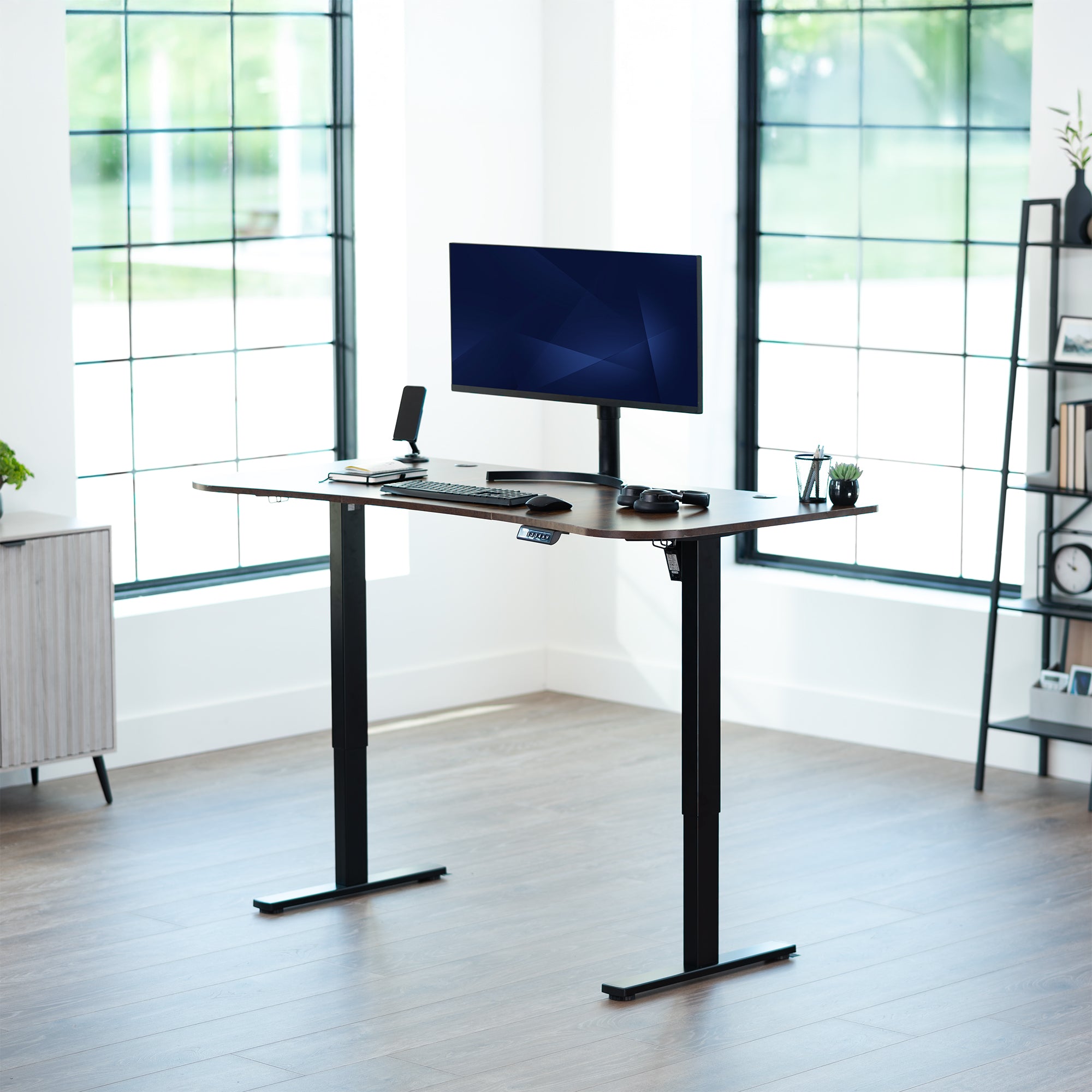 Rustic, vintage brown, electric, sit to stand, height adjustable desk in office setting.