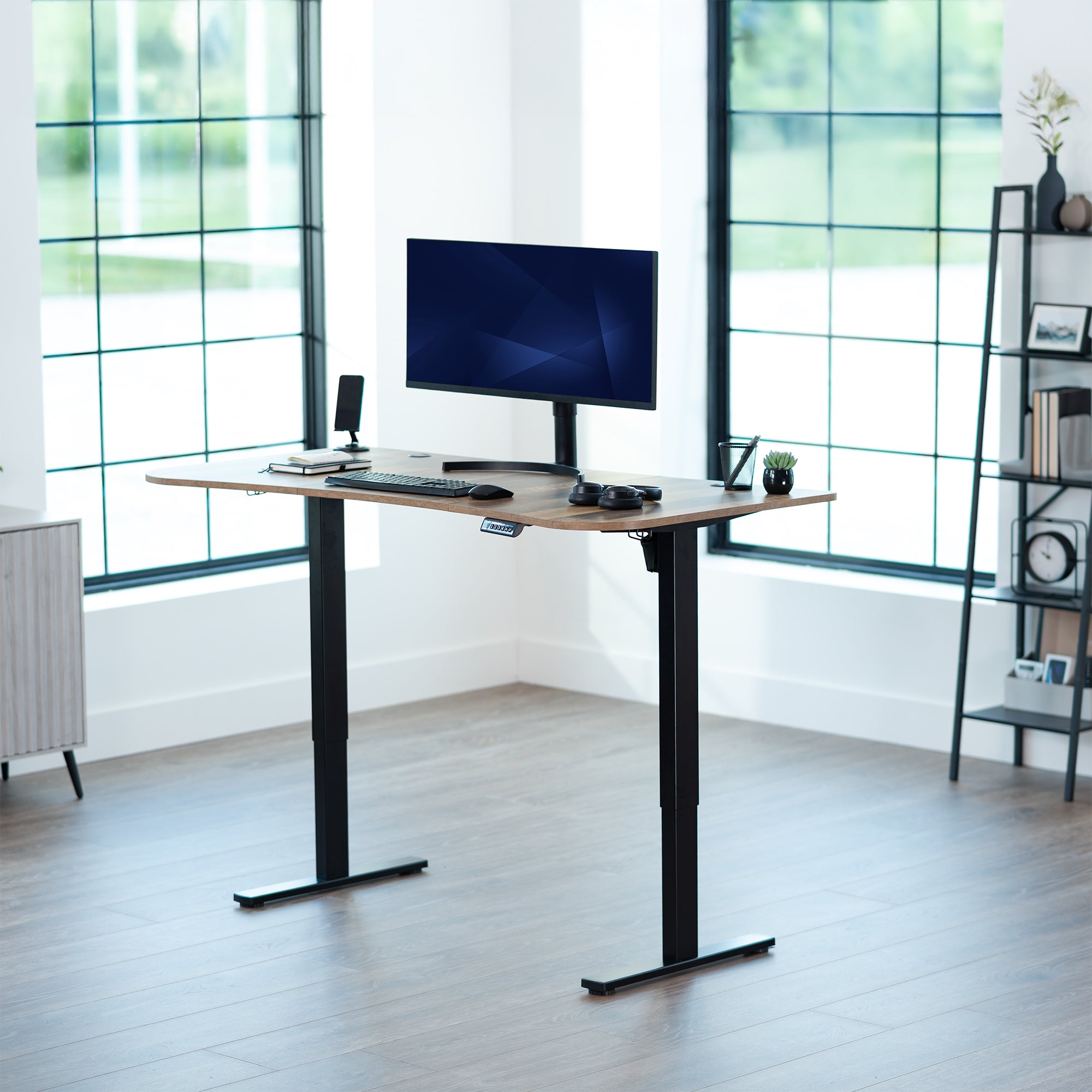 Reclaimed wood, electric, sit to stand, height adjustable desk in office setting.