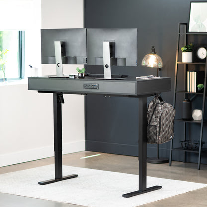 Heavy-duty electric height adjustable desk with drawers, built-in power strip, and memory controller.