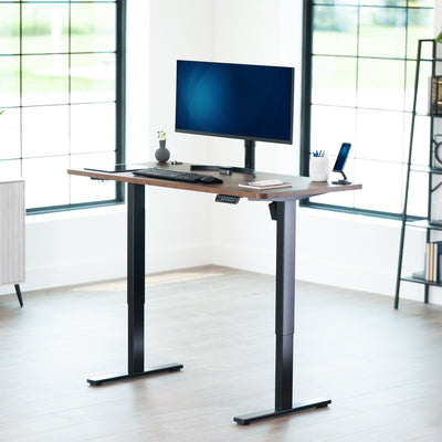 Sturdy ergonomic sit or stand active desk workstation with adjustable height using smart control panel.