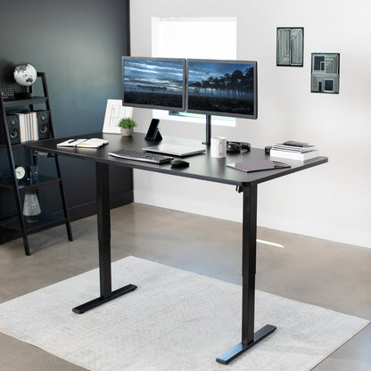 Spacious light wood electric sit-to-stand desk.